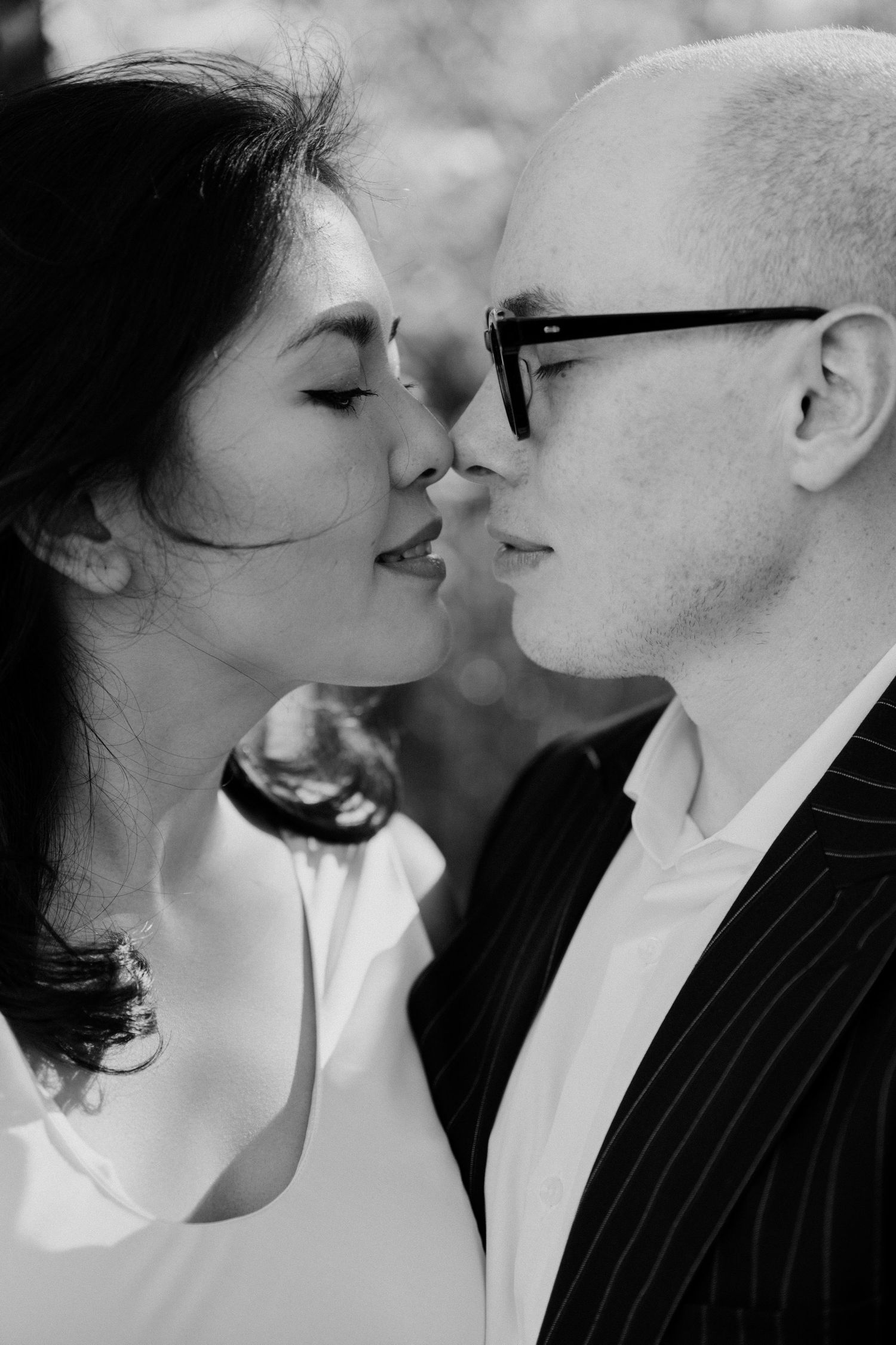 Black and white portrait of couple about to kiss before their wedding ceremony at mairie 14ème