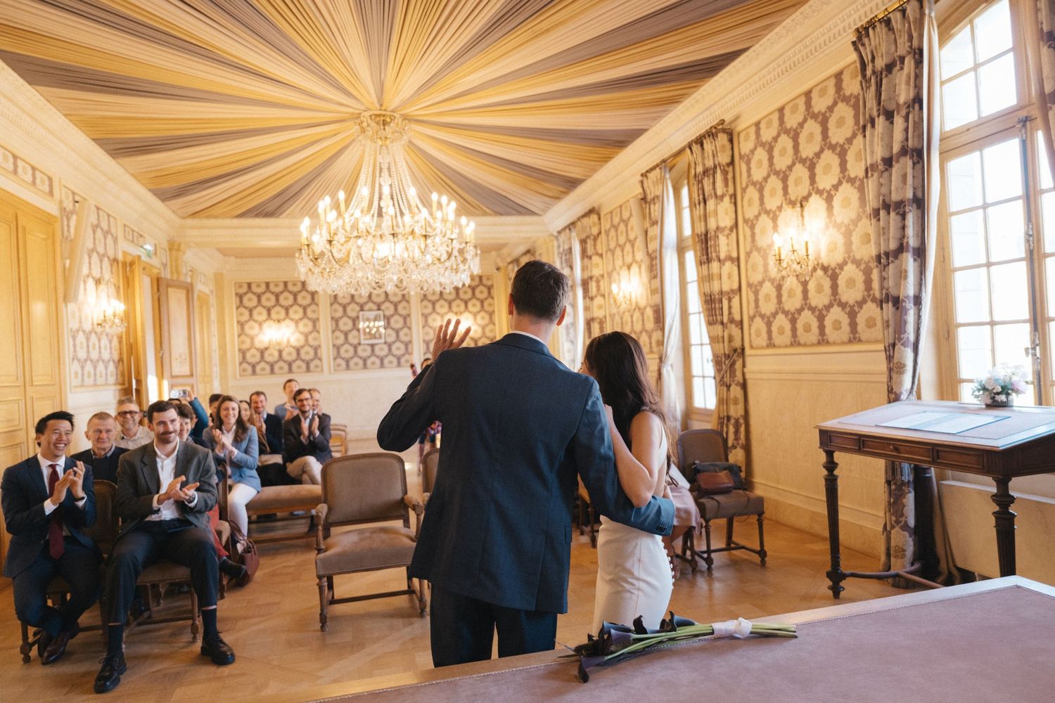 Civil wedding ceremony at Mairie de Levallois-Perret, couple waving to their guests