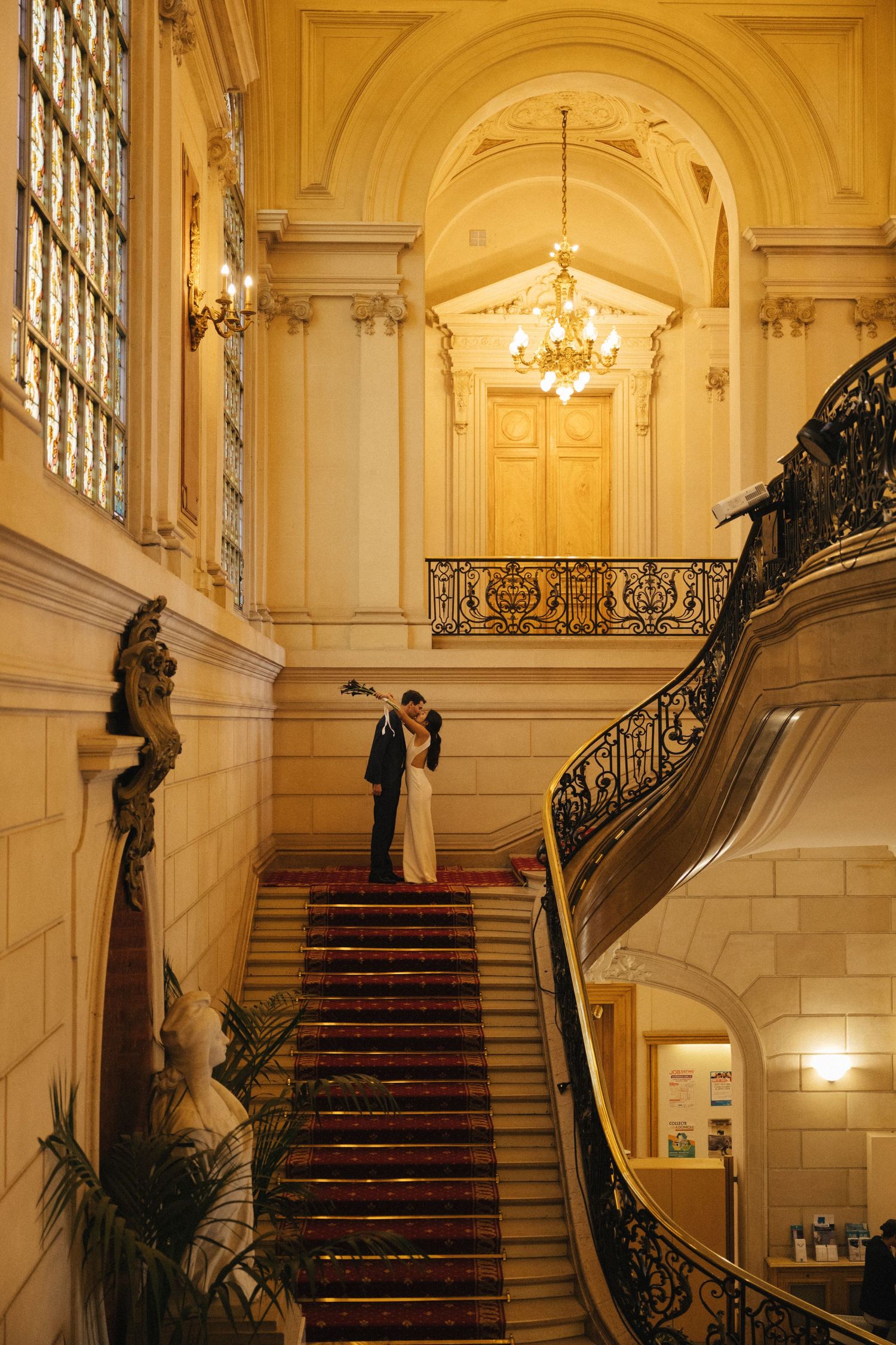 Civil wedding ceremony at Mairie de Levallois-Perret, couple kissing on the stairs hotel de ville