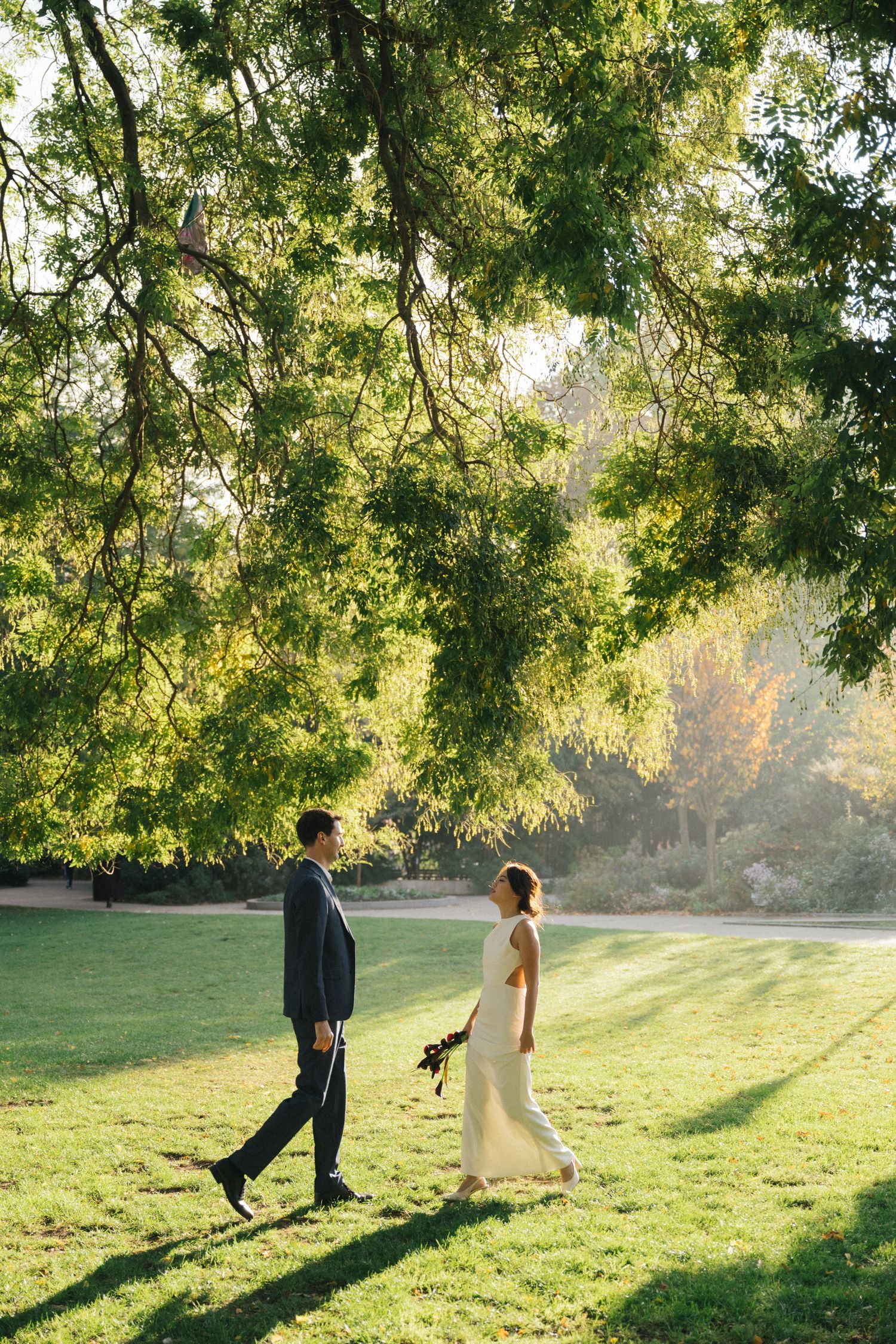 Wedding couple portrait at parc de la planchette, groom and the bride walk towards each other