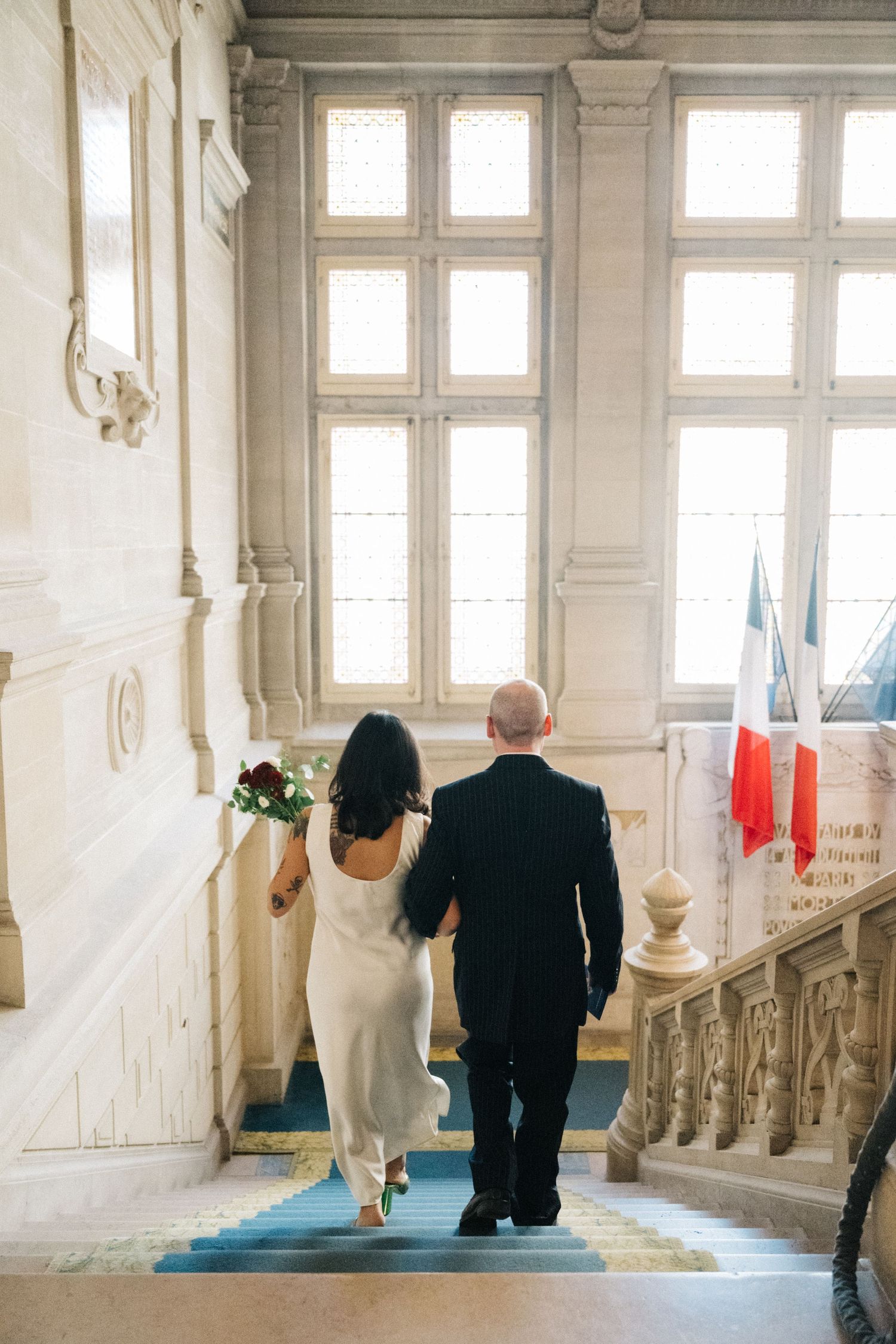 Civil wedding at mairie 14ème Paris, the bride and groom walking down the stairs