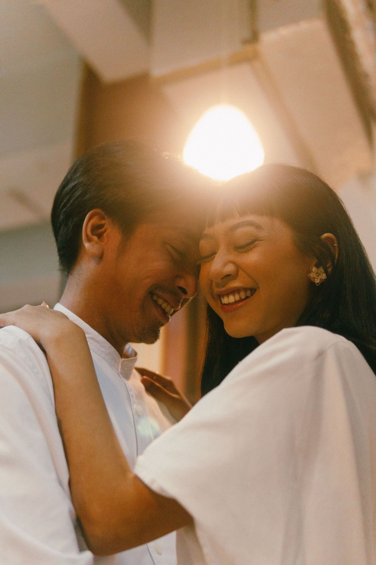 Wong Kar Wai inspired couple photoshoot in North Jakarta, couple smiling under a lamp