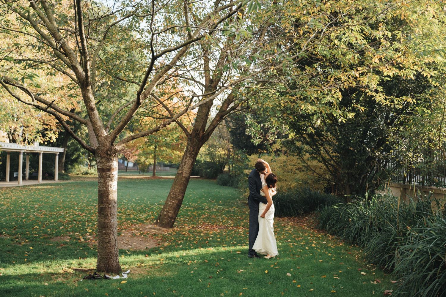 Wedding couple portrait at parc de la planchette, groom and bride kiss each other
