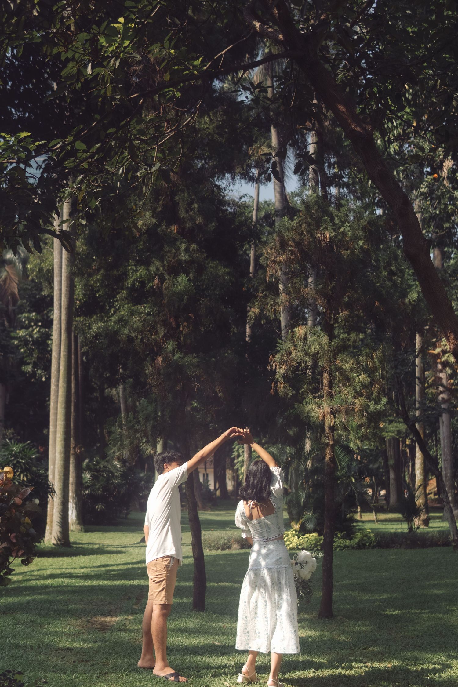Taman Langsat Jakarta pre-wedding photoshoot, couple dancing and doing a twirl