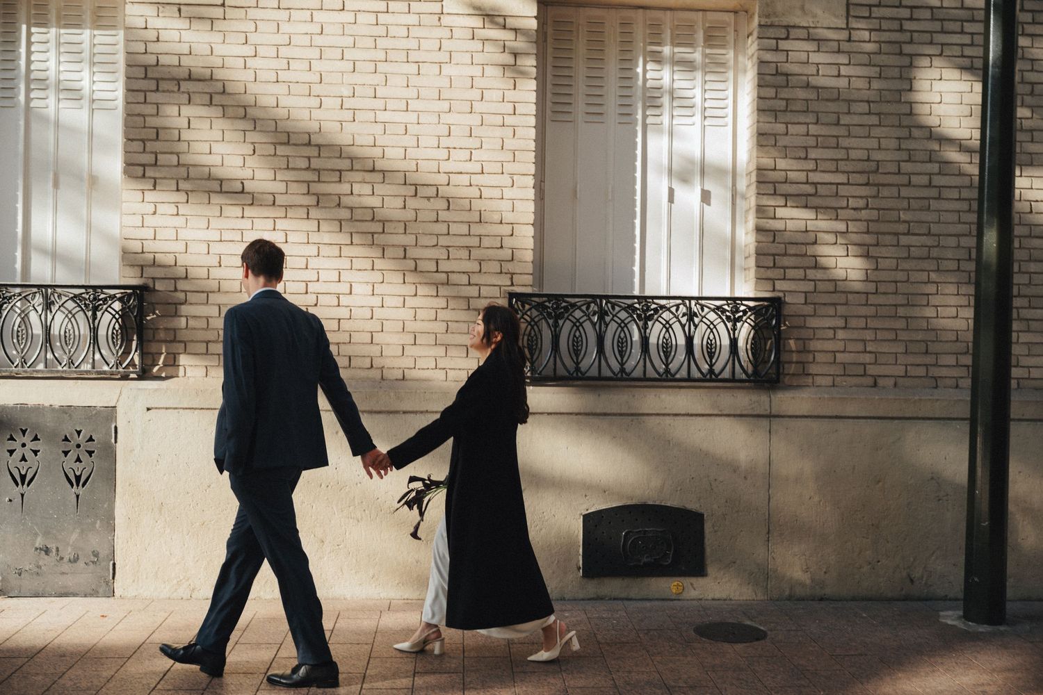 Civil wedding ceremony at Mairie de Levallois-Perret, bride and groom walking towards hotel de ville