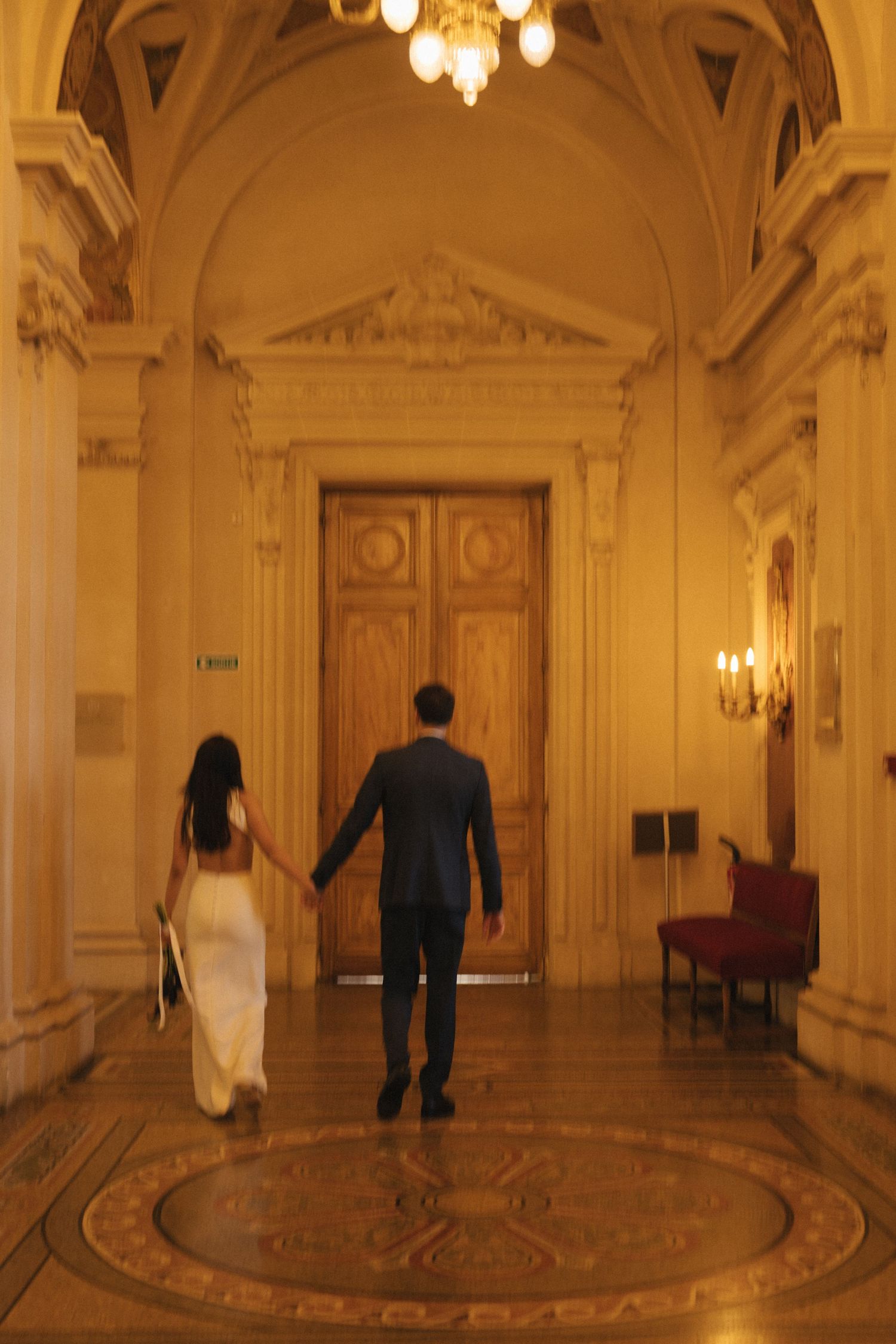 Civil wedding ceremony at Mairie de Levallois-Perret, bride and groom walking down the hallway