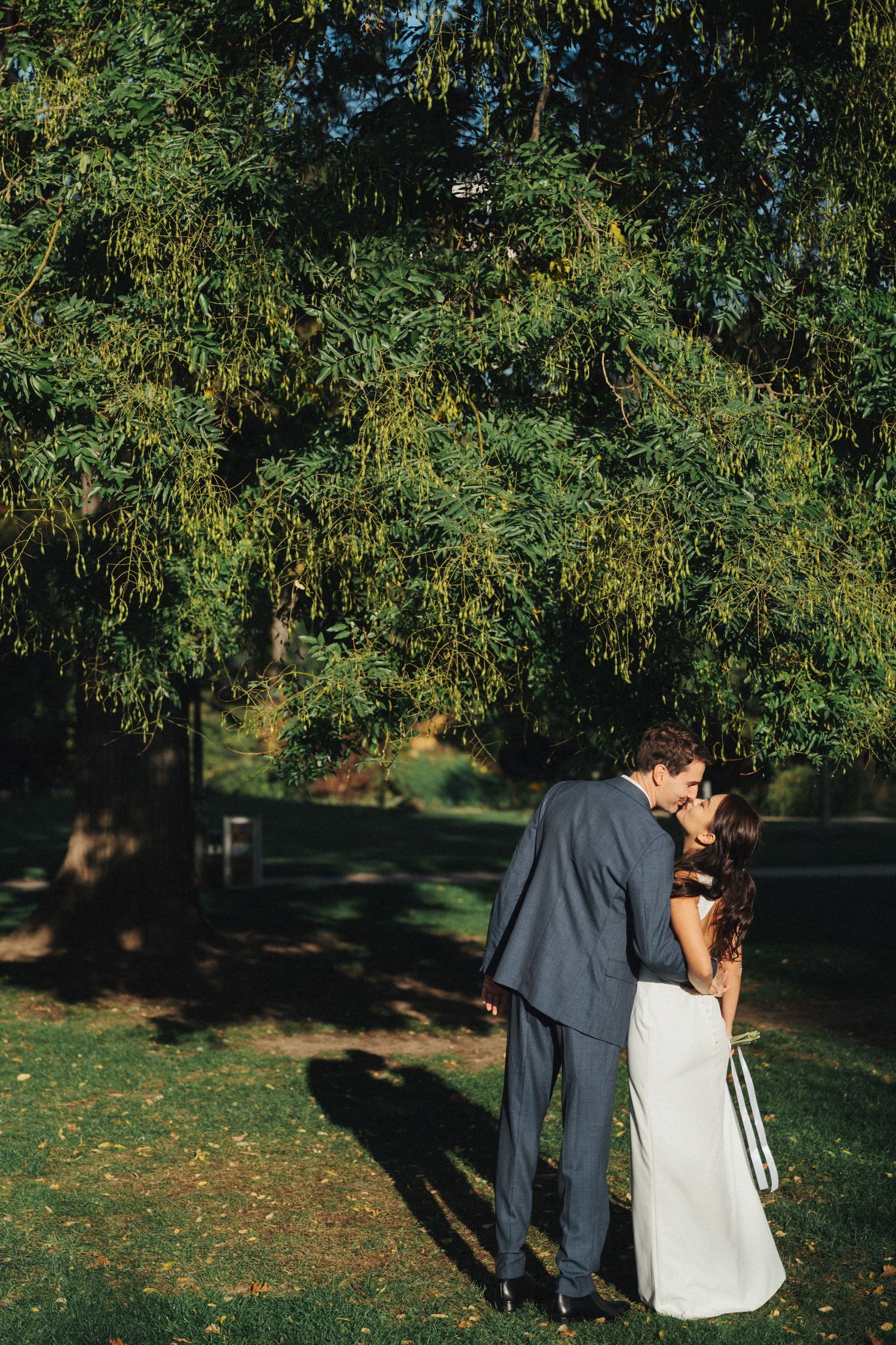 Wedding couple portrait at parc de la planchette, groom and bride kissing each other