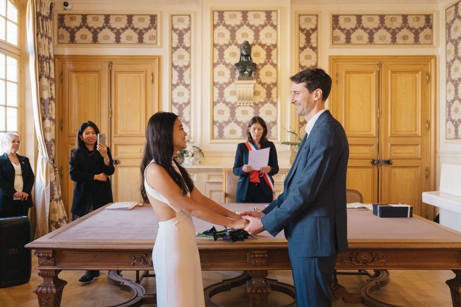 Civil wedding ceremony at Mairie de Levallois-Perret, bride and groom holding hand