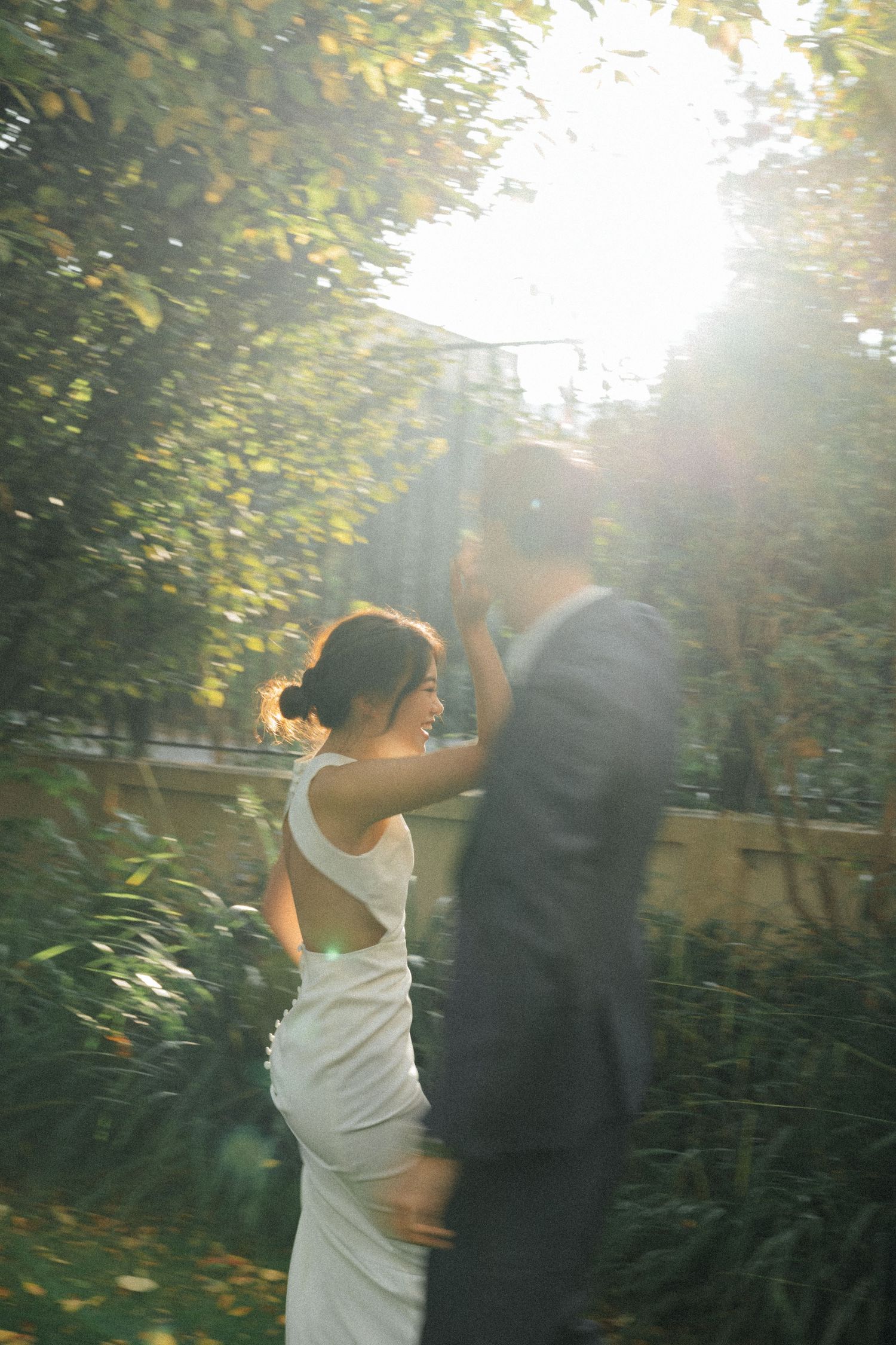 Wedding couple portrait at parc de la planchette, groom and bride dancing around with each other
