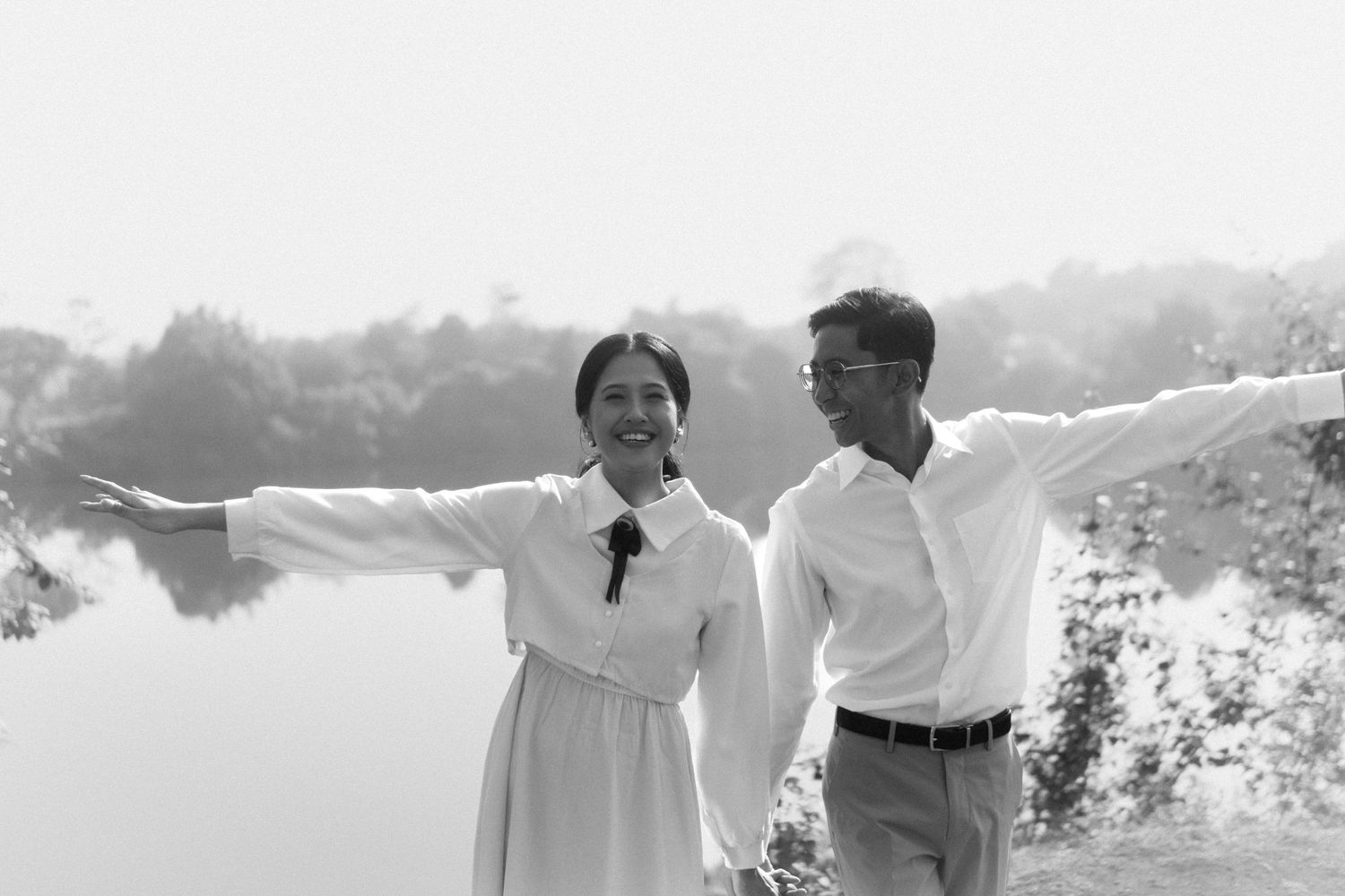 Ghibli inspired photoshoot, the wind rises. The bride and groom standing on an open field black and white