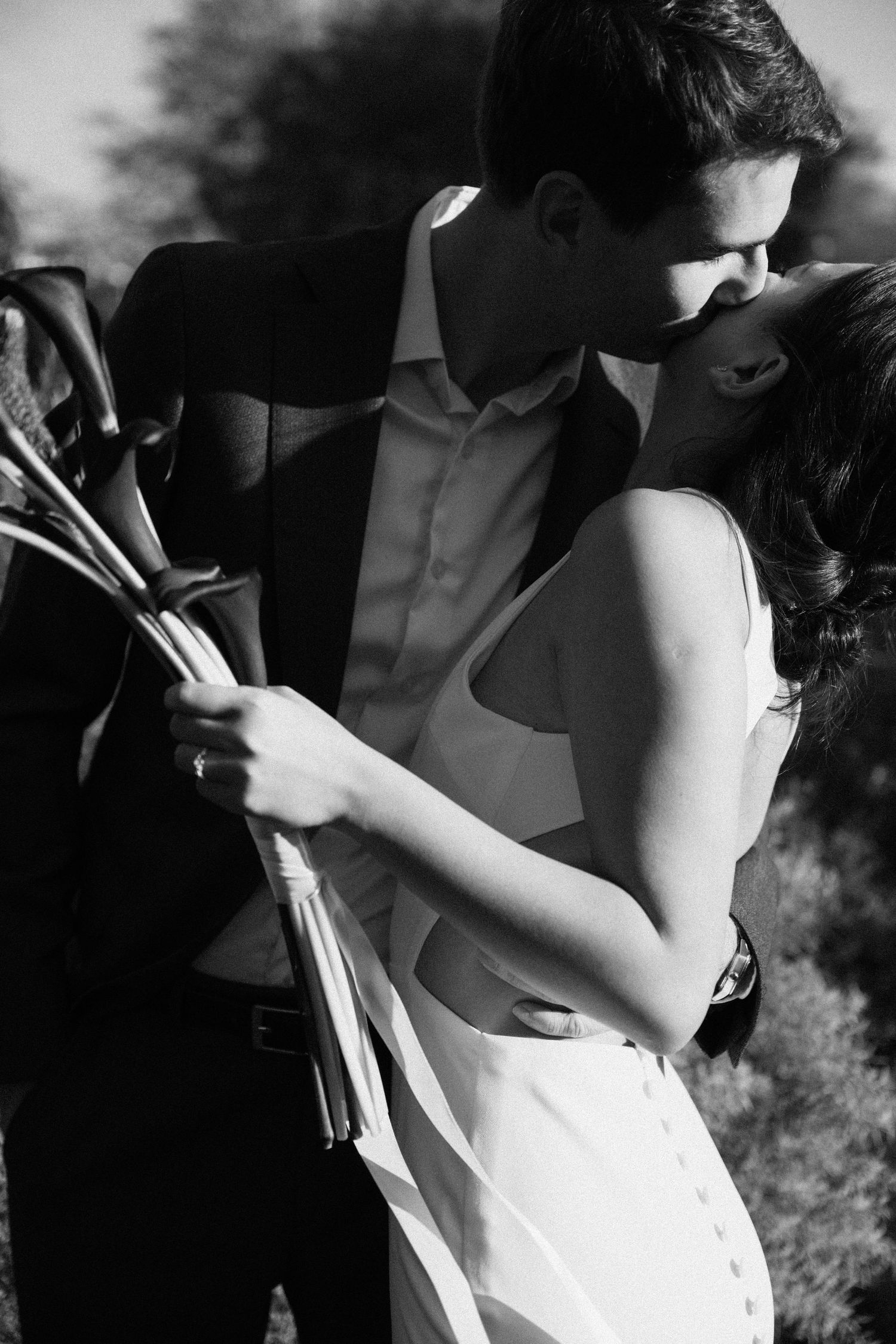 Wedding couple portrait at Parc de la Planchette, groom kissing bride's cheek
