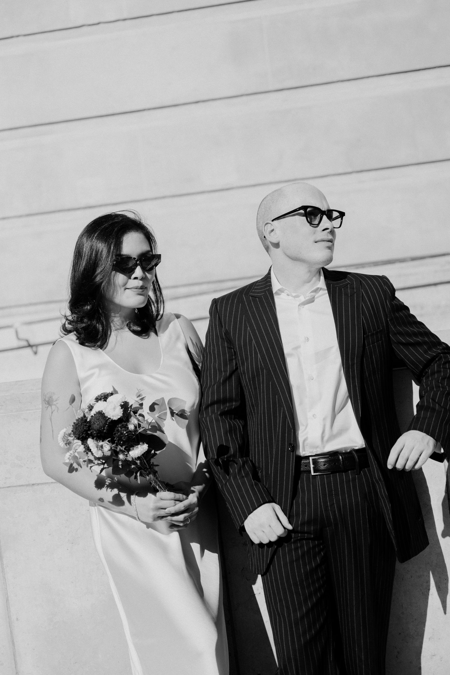 Couple portrait at mairie 14ème Paris, bride and groom wearing sunglasses