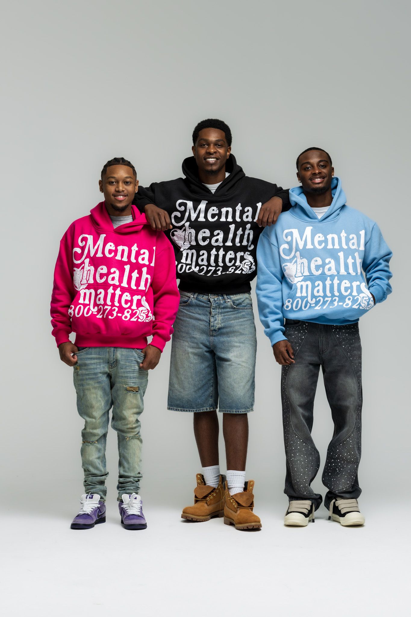 Several children stand together wearing hoodies with 'Mental Health Matters' text in pink and blue colors.