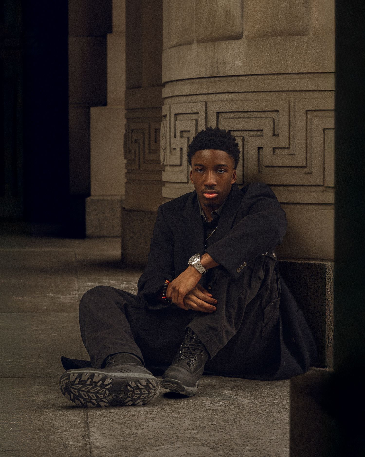 Dark nighttime series of photos showing a person in casual clothing sitting near a wall at night in an urban setting.