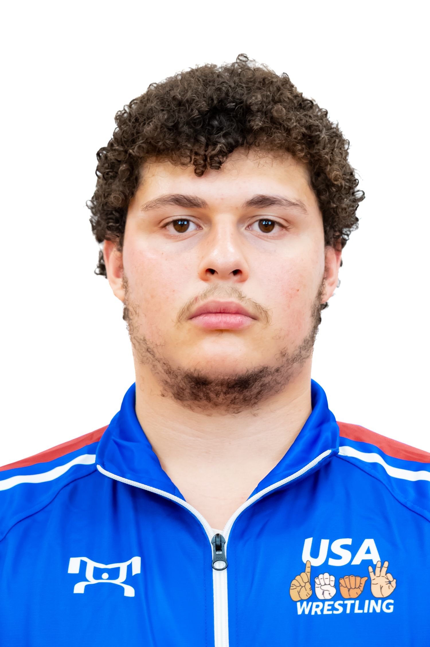 Athlete wearing blue USA Wrestling team jacket with curly hair against white background.