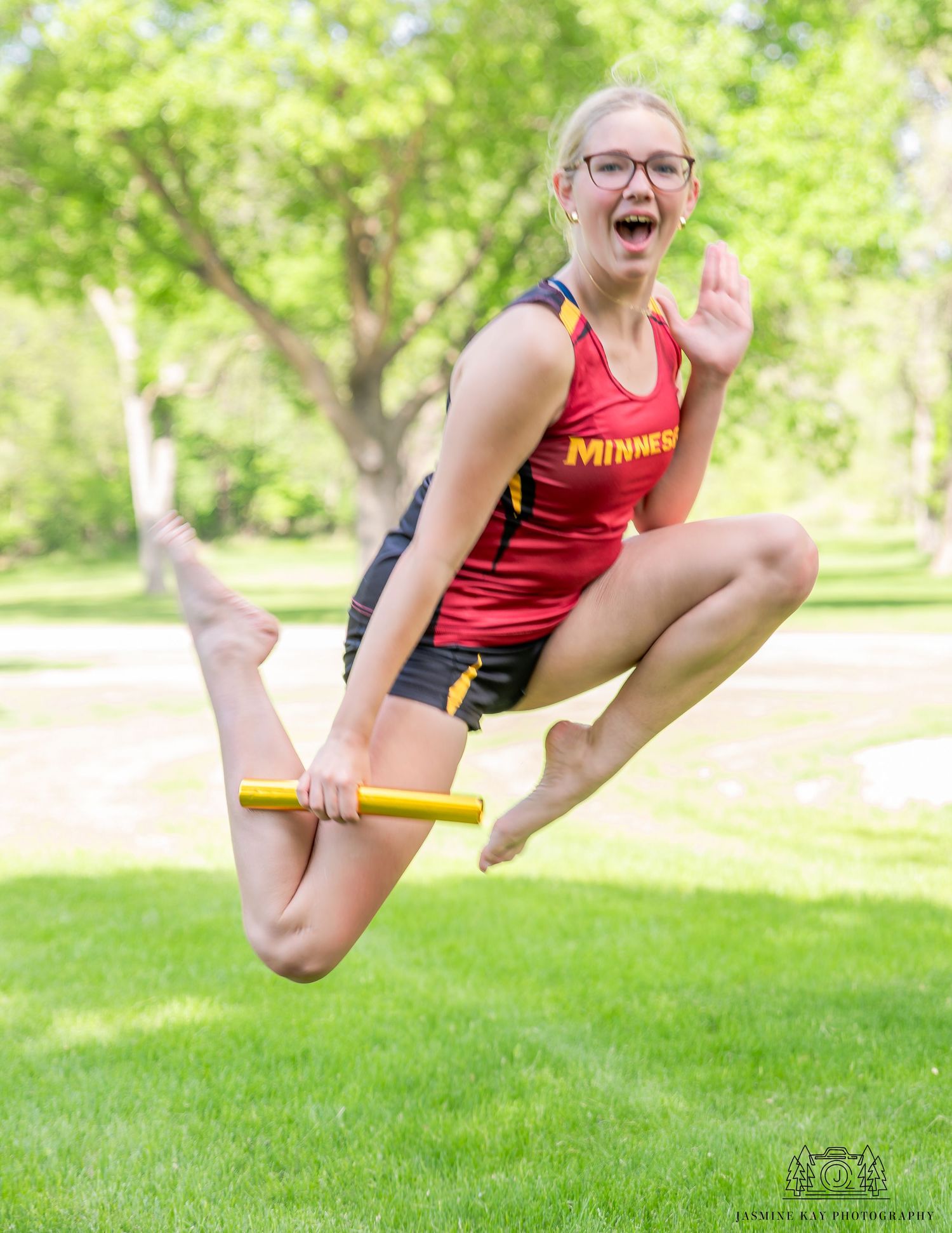 A sequence of action shots showing someone jumping in a red athletic uniform on a sunny grassy lawn.
