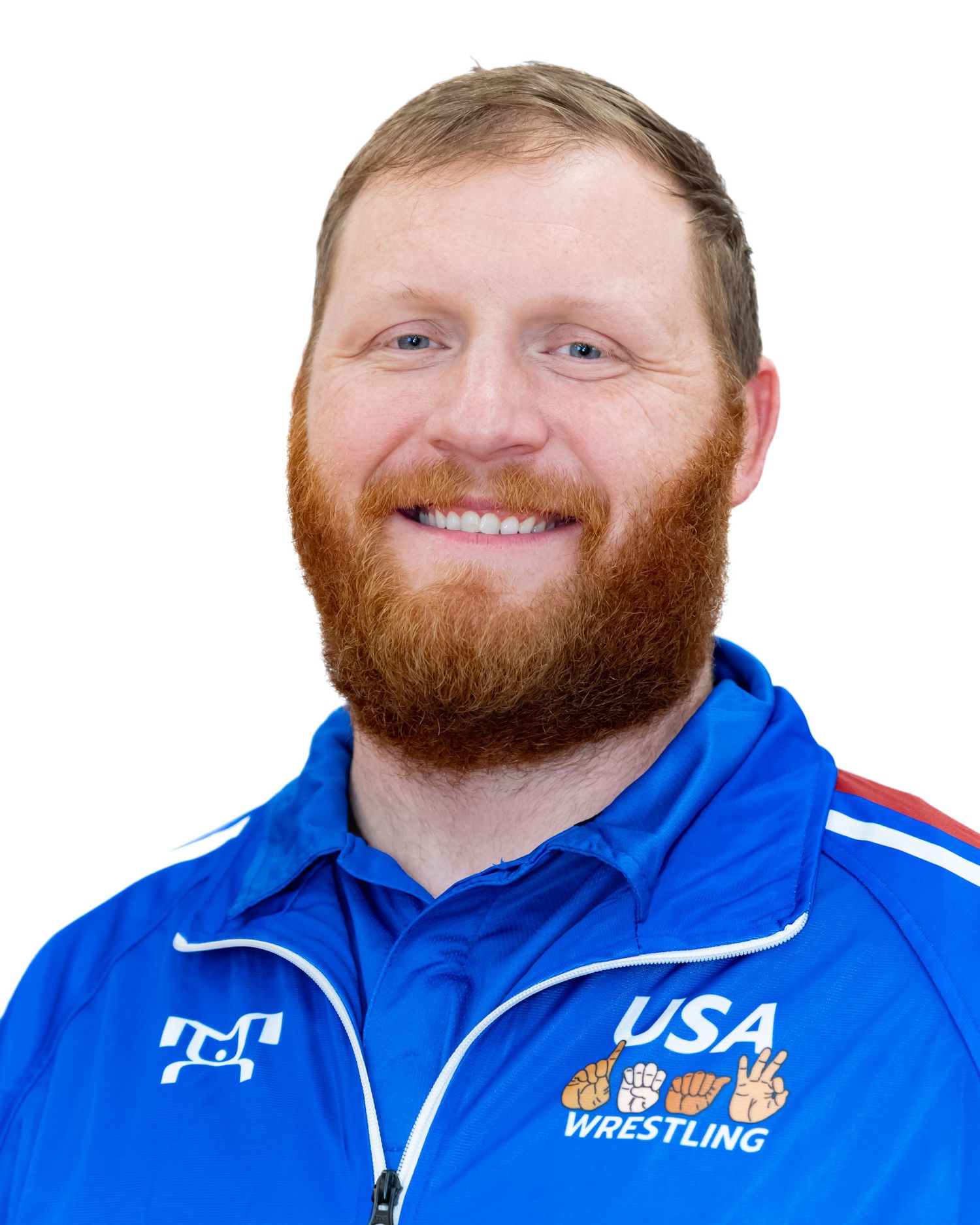 Person wearing USA Wrestling blue team jacket smiling against white background.