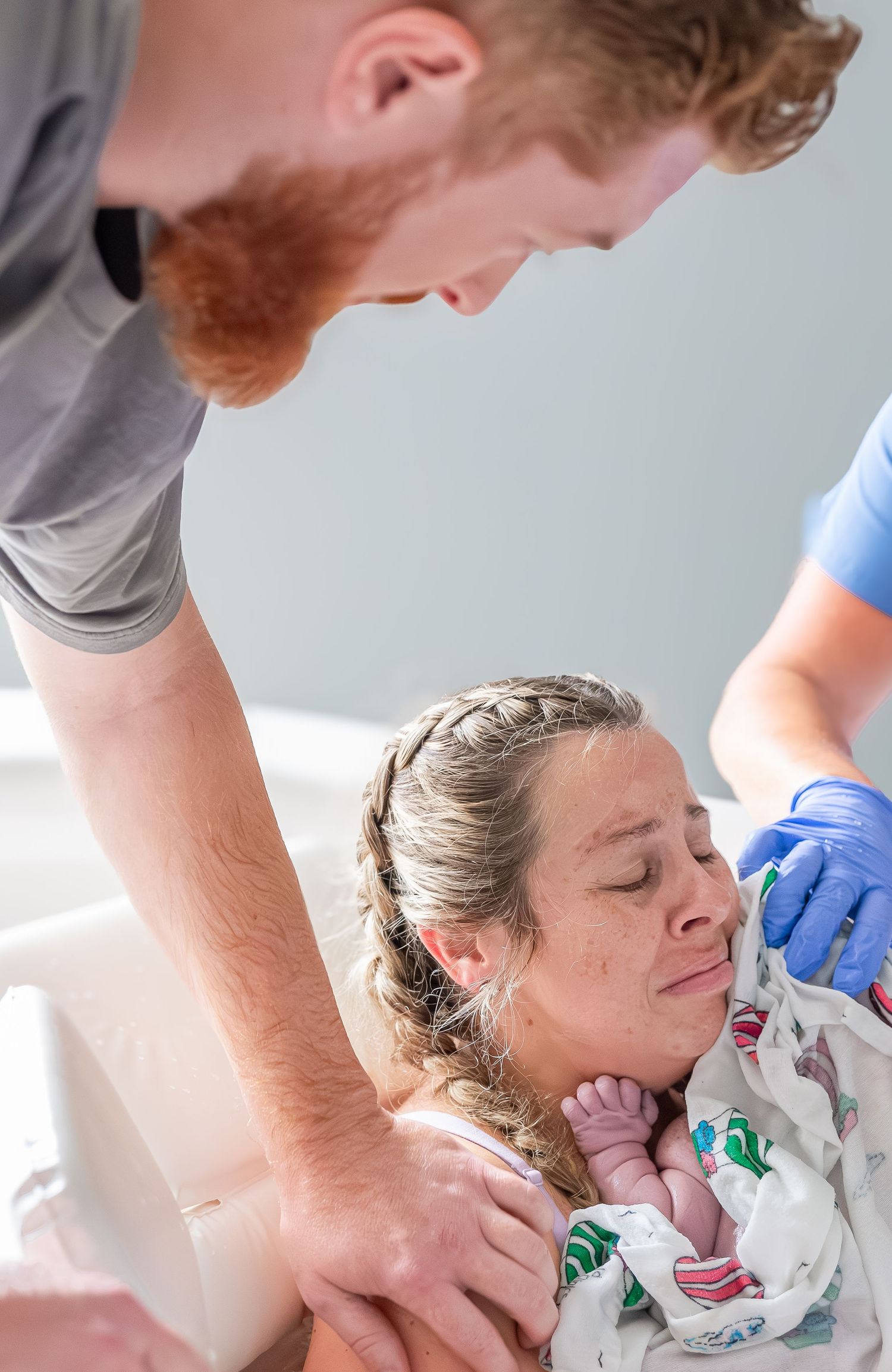 Medical professional in blue gloves performs a thyroid examination on a patient during a routine checkup.