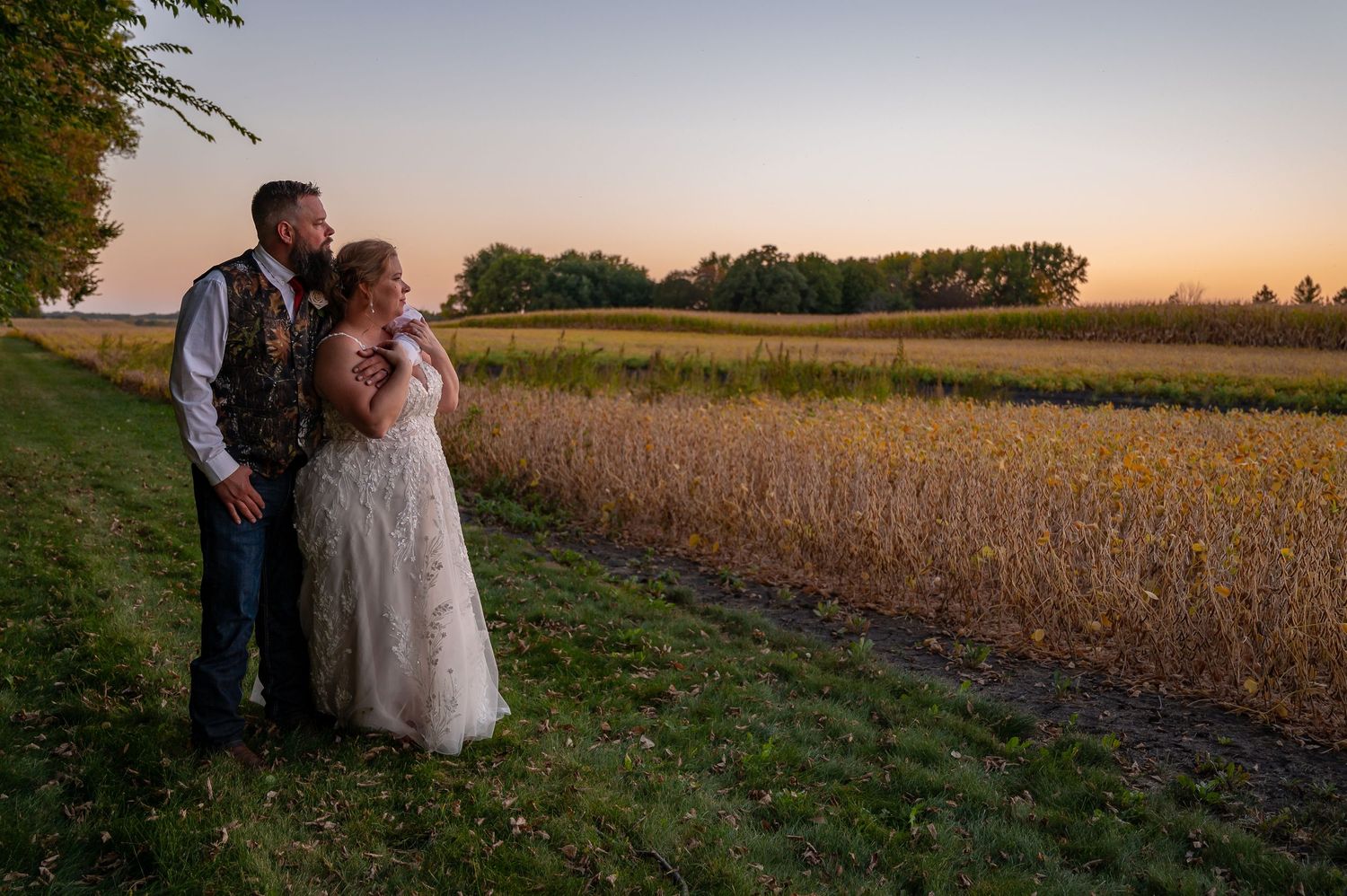 Romantic sunset portrait in a rural field with golden hour lighting.