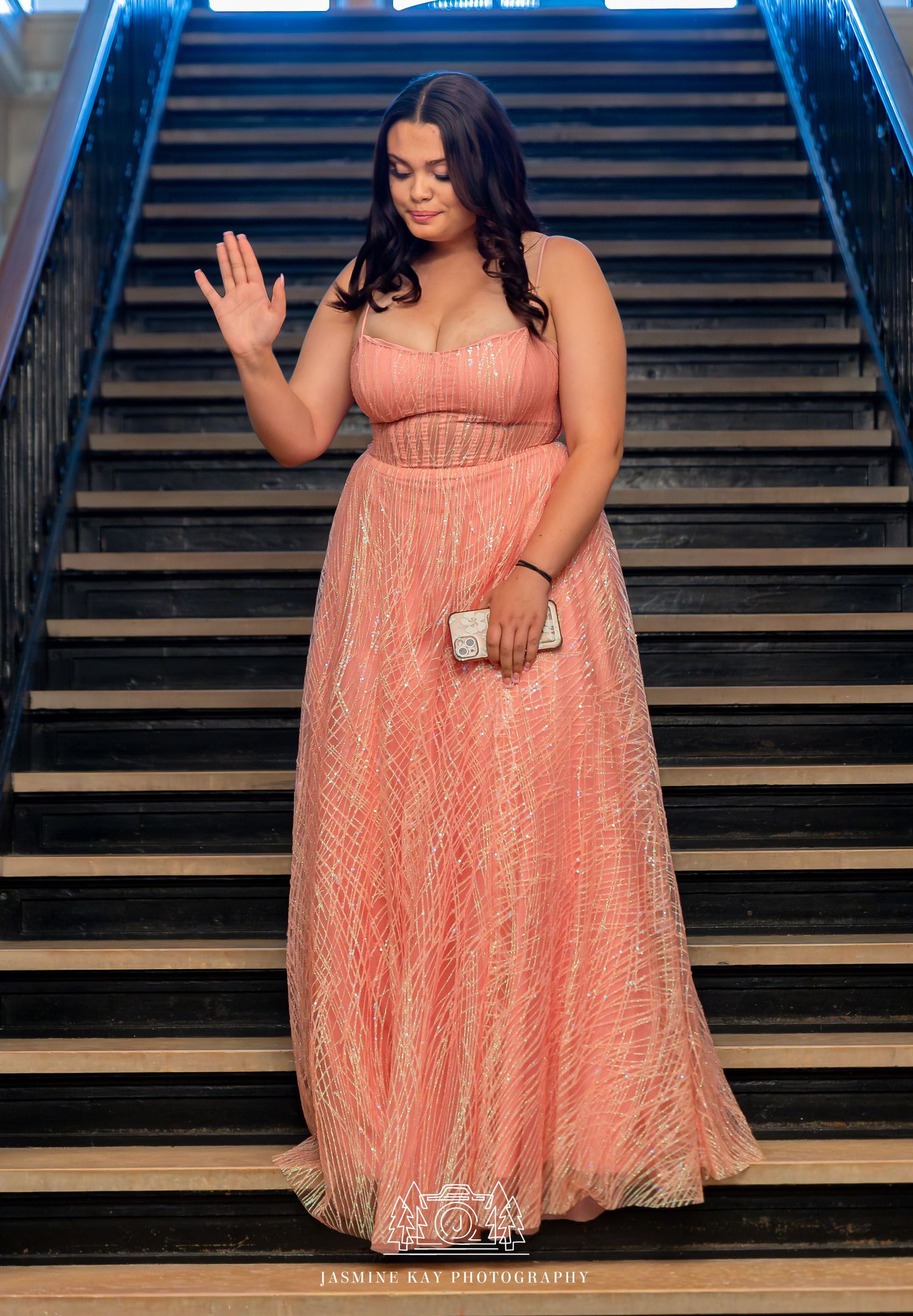 A series of photos showing someone in a peach-colored lace dress descending elegant dark wooden stairs.