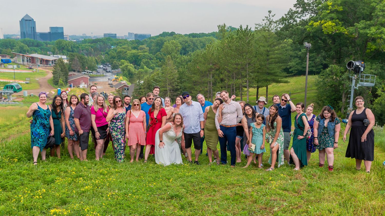 A panoramic collage of outdoor wedding party photos showing groups of guests gathered in scenic countryside settings.