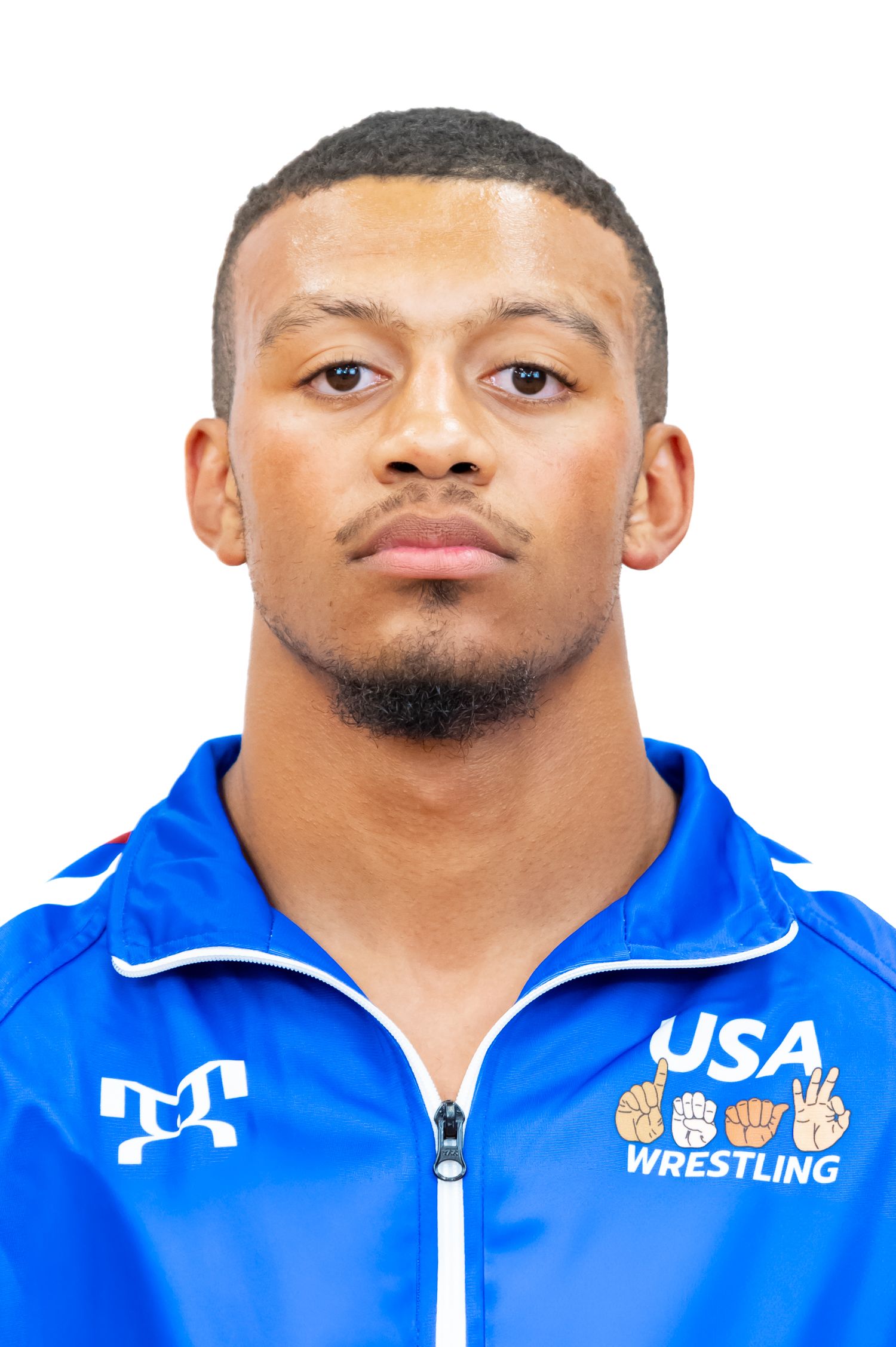Athlete in USA Wrestling team uniform jacket with short hair and facial hair.