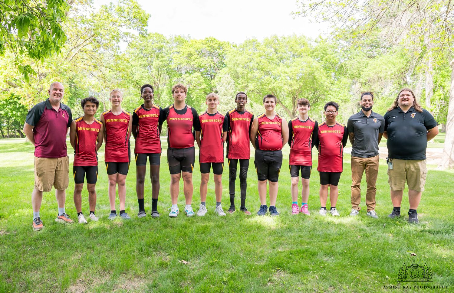 A panoramic collage of sports team members standing in a row outdoors on grass with trees in the background.