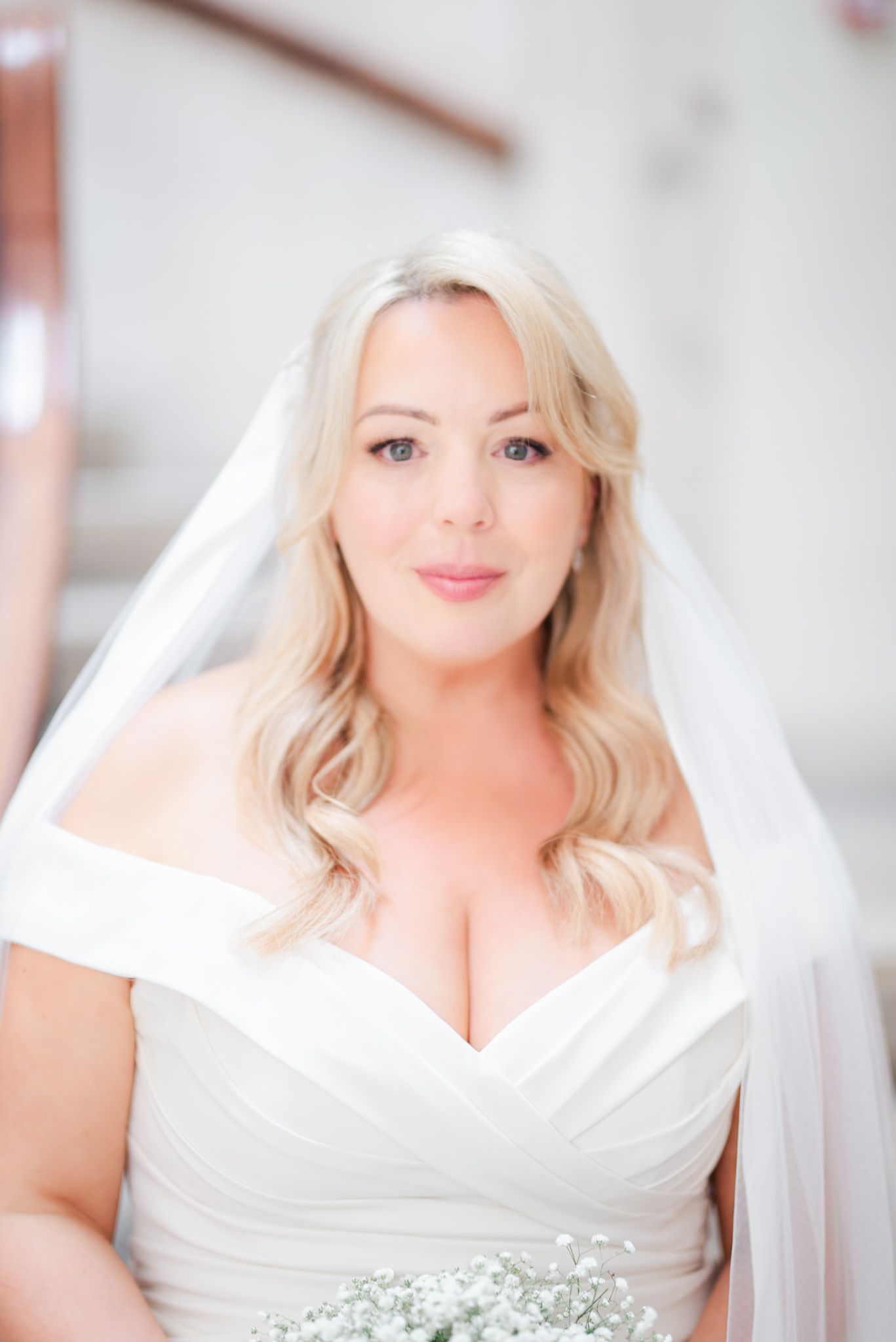 Elegant bridal portrait featuring a sweetheart neckline gown and flowing veil.