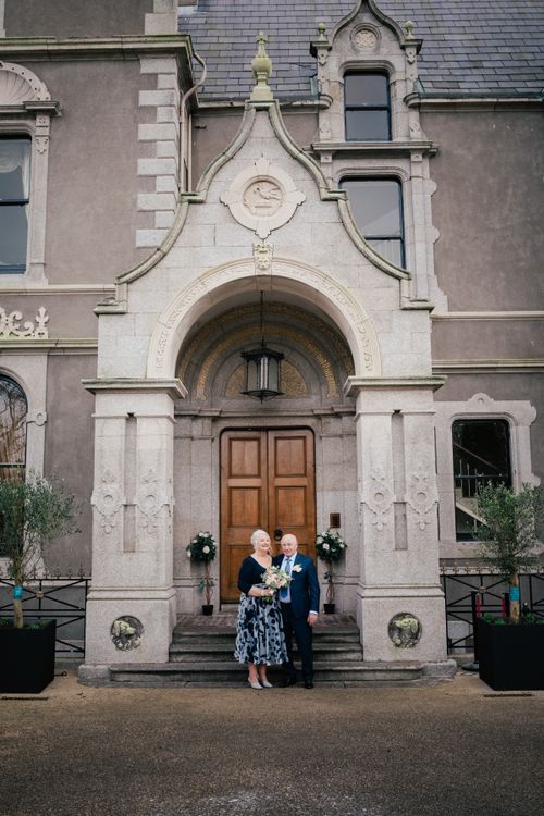 Elegant Gothic revival church entrance with stone archway, wooden doors and decorative architectural details.