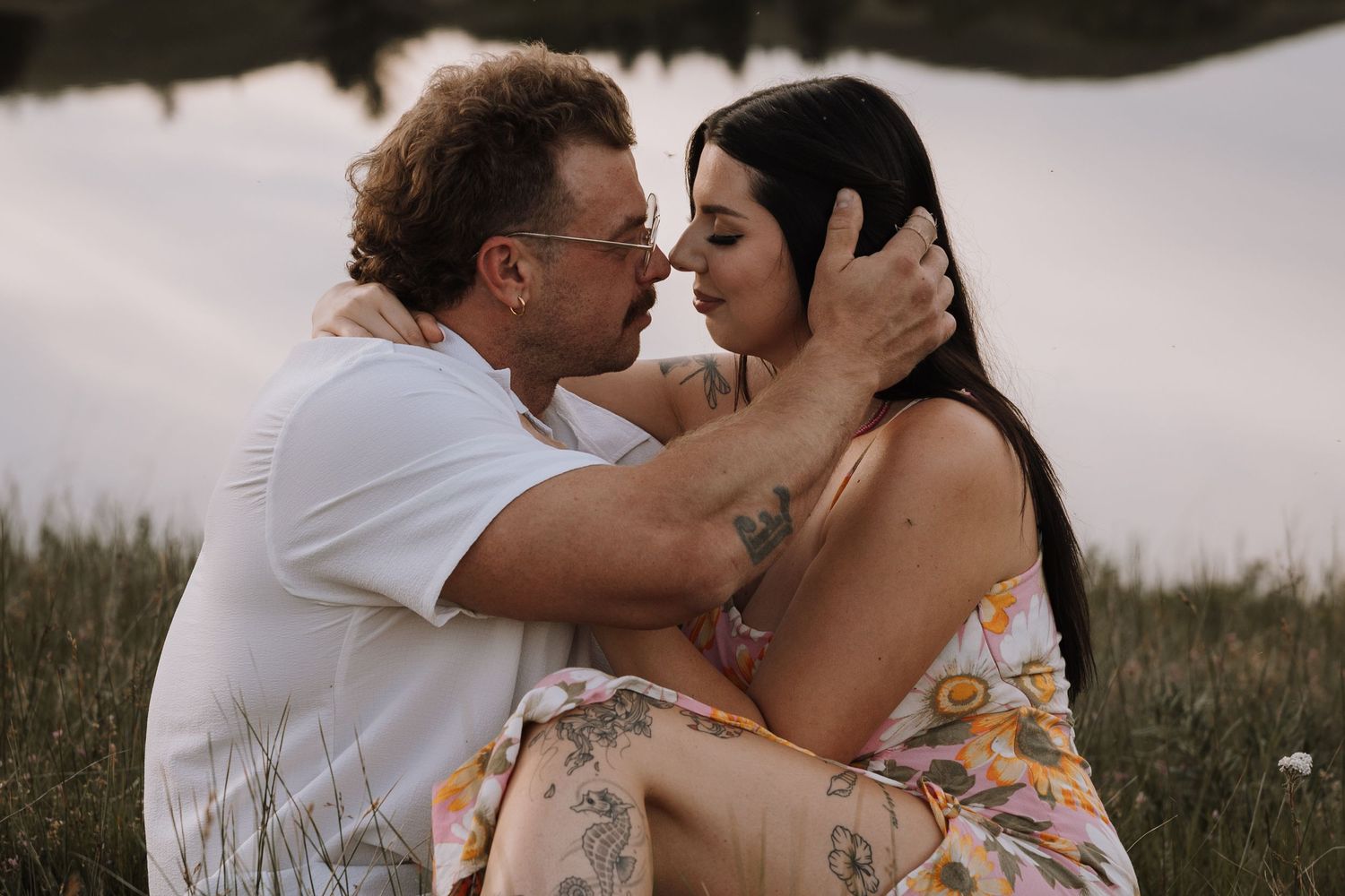 Romantic lakeside anniversary portrait of a couple embracing at golden hour, sharing an intimate moment surrounded by nature Kamloops BC