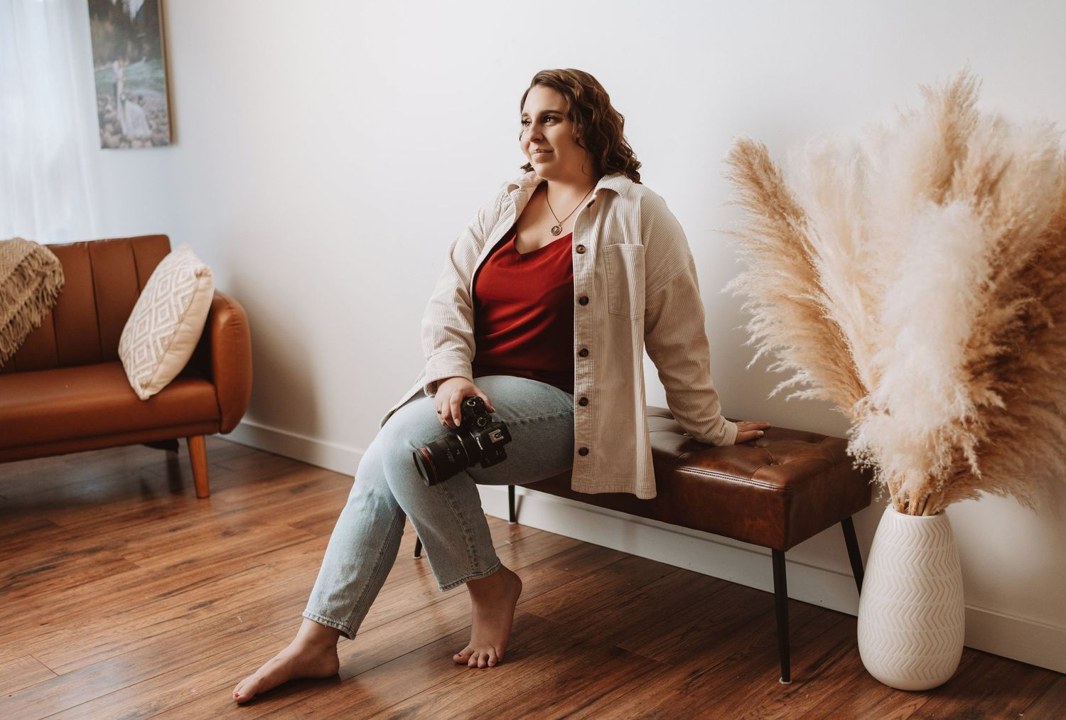 Indoor lifestyle portrait with pampas grass decor and modern furniture in natural lighting.