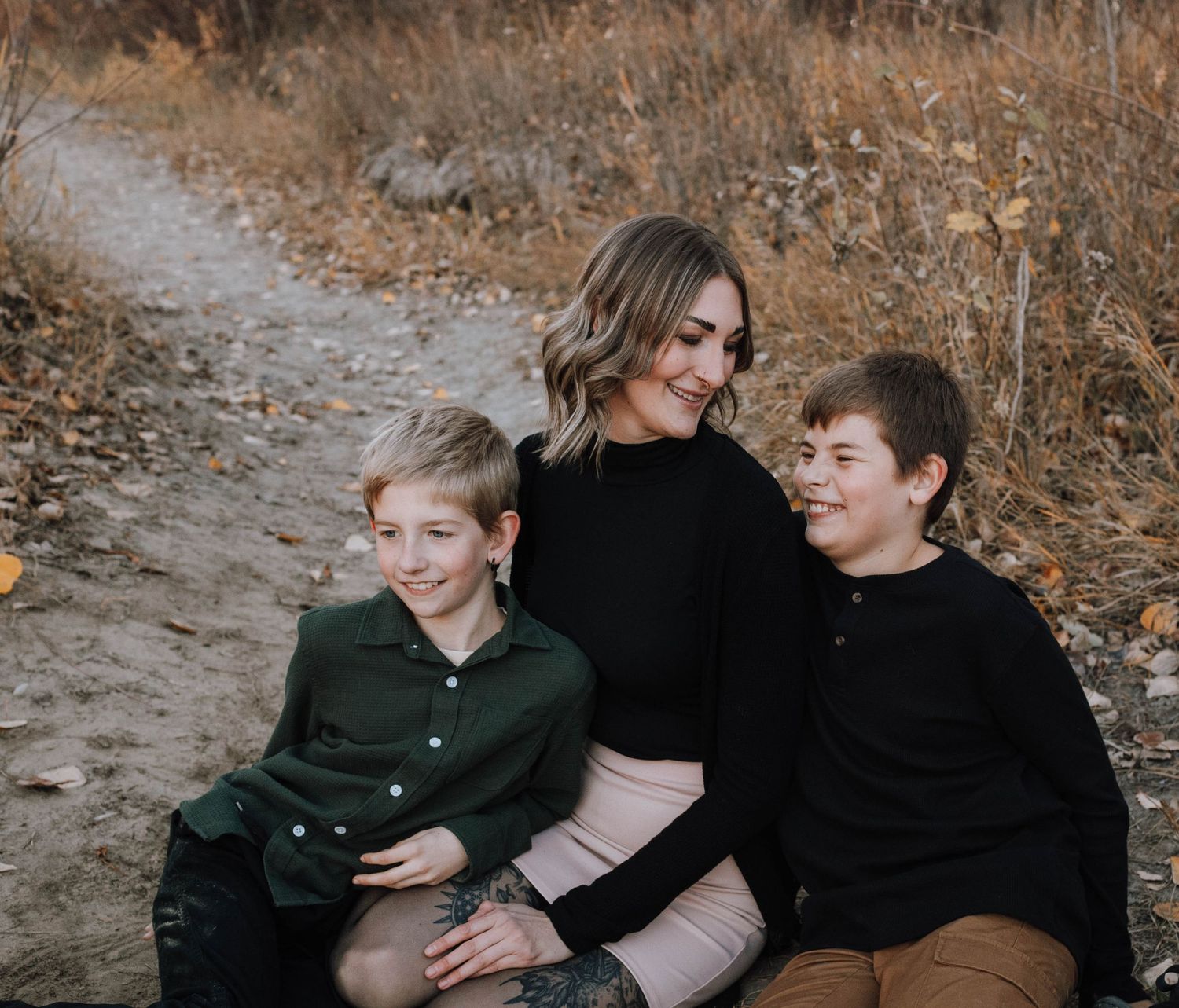 A casual family portrait on a winding autumn trail.