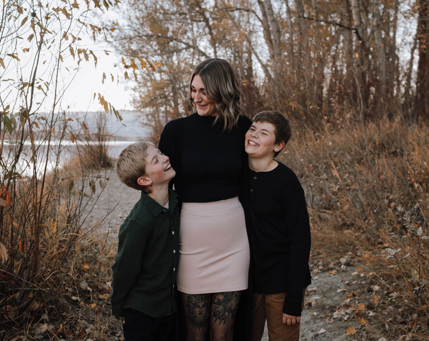 A candid family moment captured by the lake during autumn.