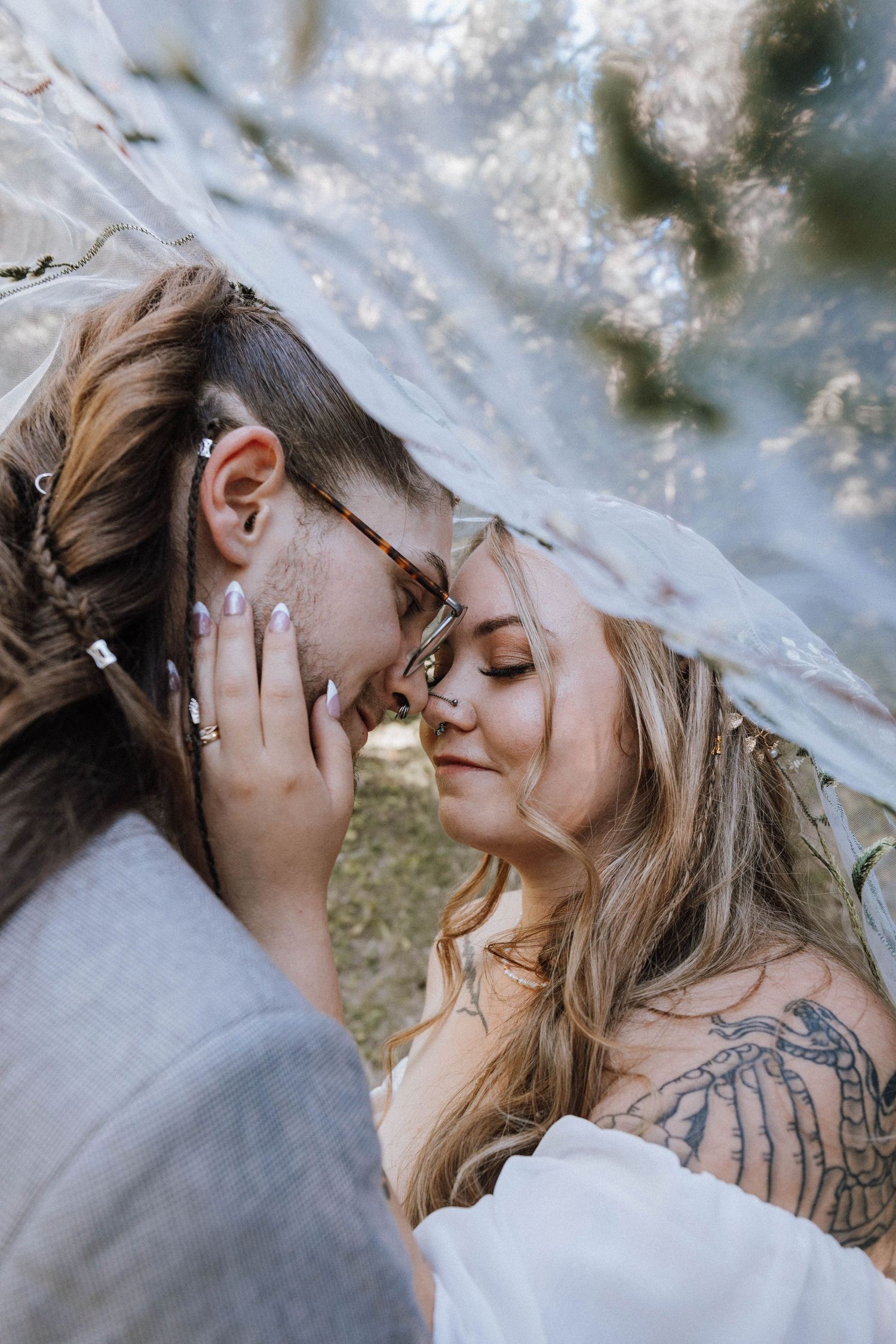 Four romantic close-up shots showing a tender kiss in a soft, dreamy outdoor setting with natural lighting.