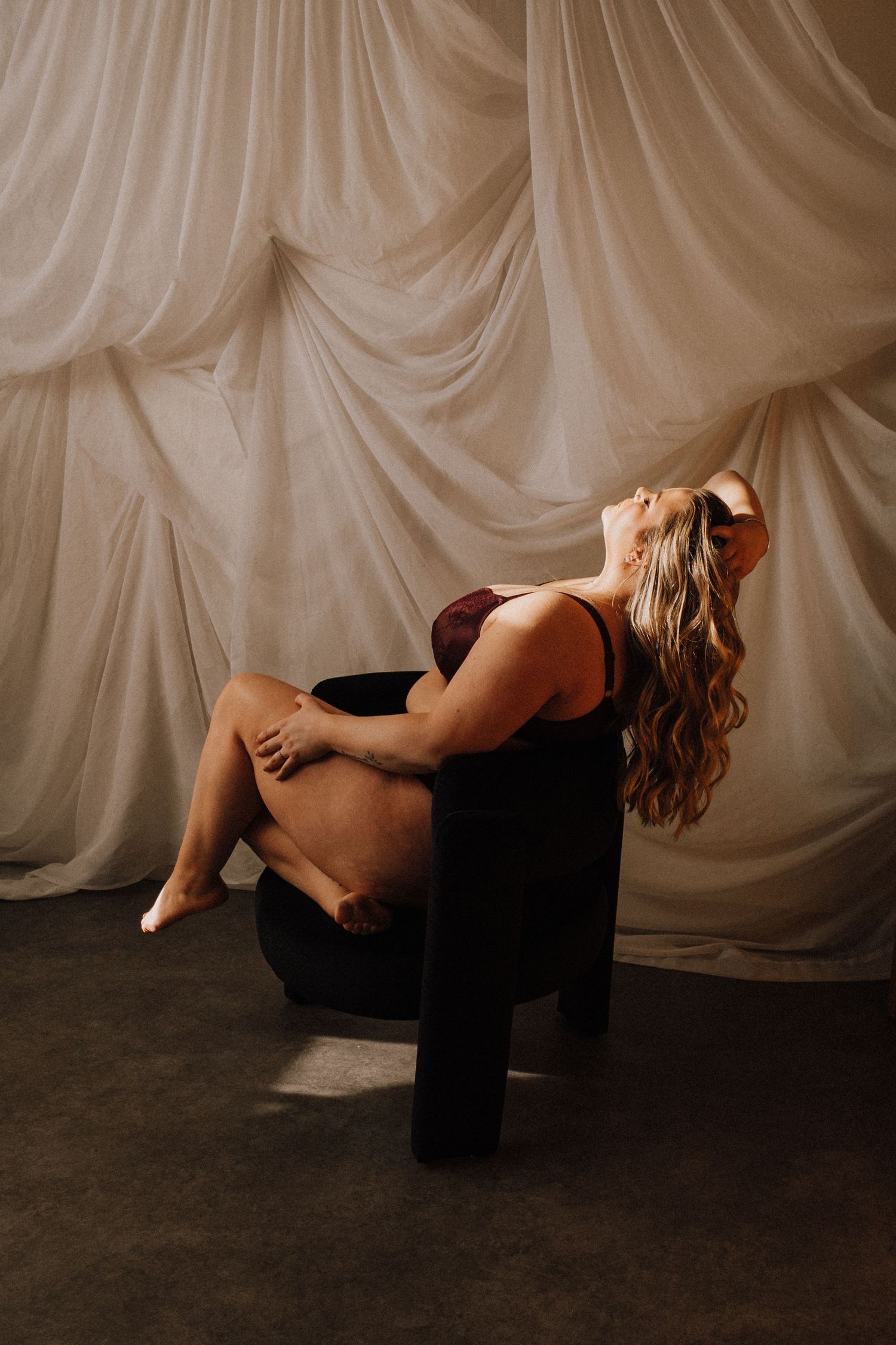 A series of black and white dance poses captured against a draped fabric backdrop showing graceful movement and form.