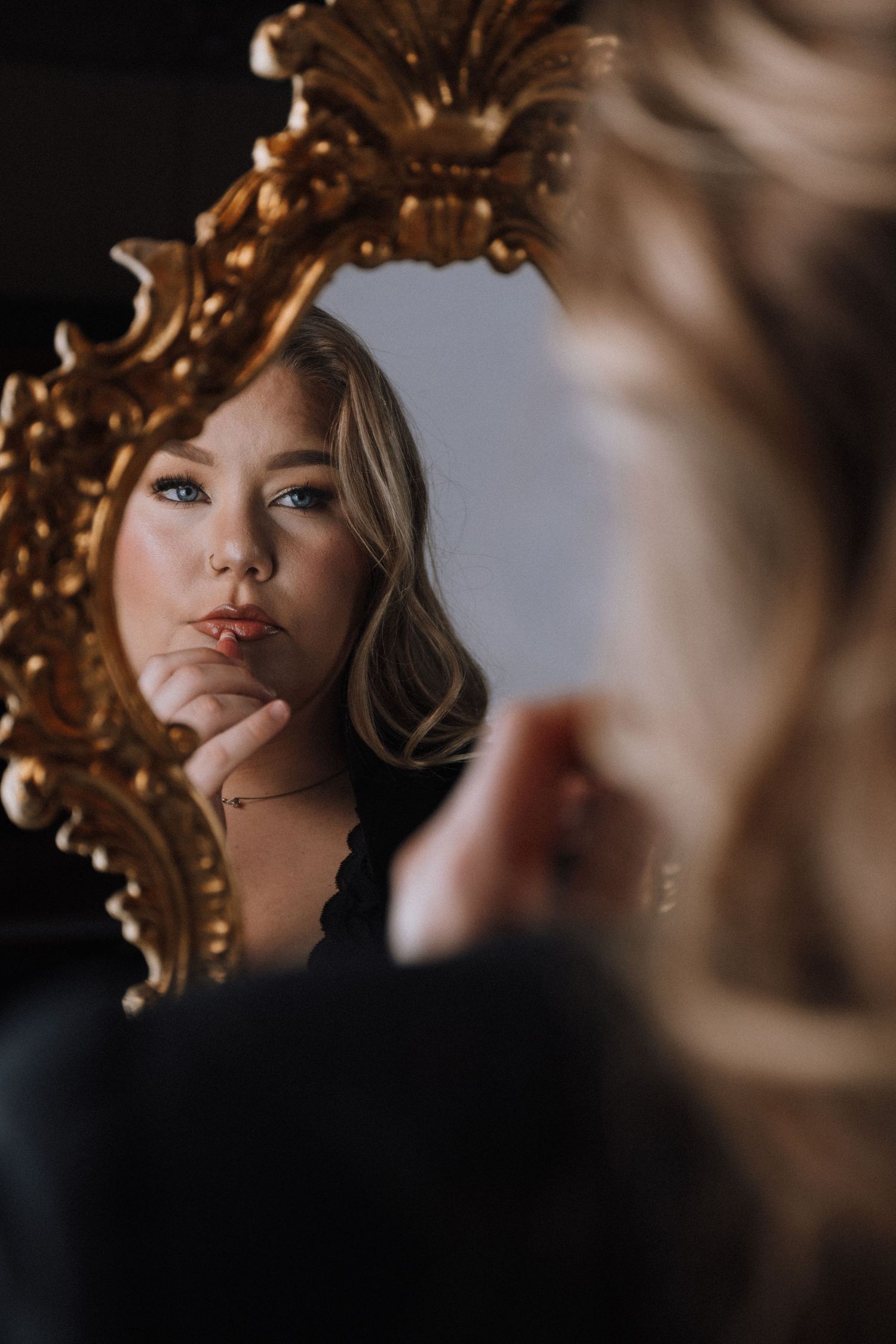 Artistic portrait series showing close-up shots through an ornate gold frame with soft lighting and dramatic shadows.
