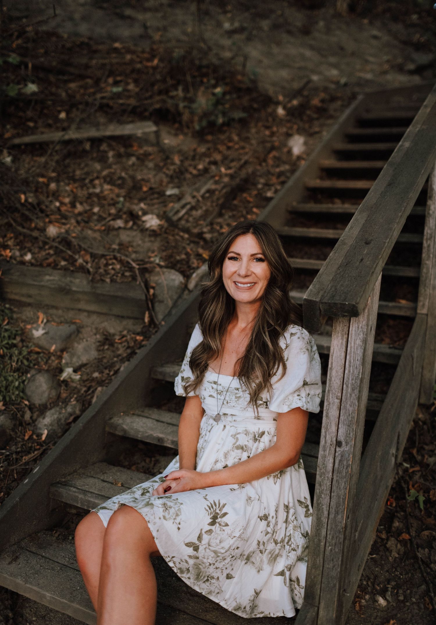 Rustic wooden stairs frame a dreamy autumn scene with soft natural lighting.
