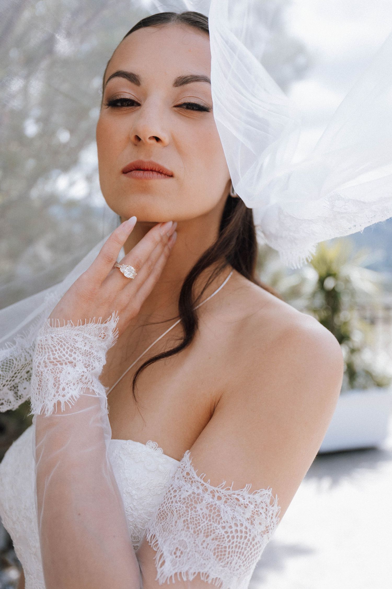 Ethereal bridal portrait series showing delicate lace details and flowing white veil in soft natural lighting.