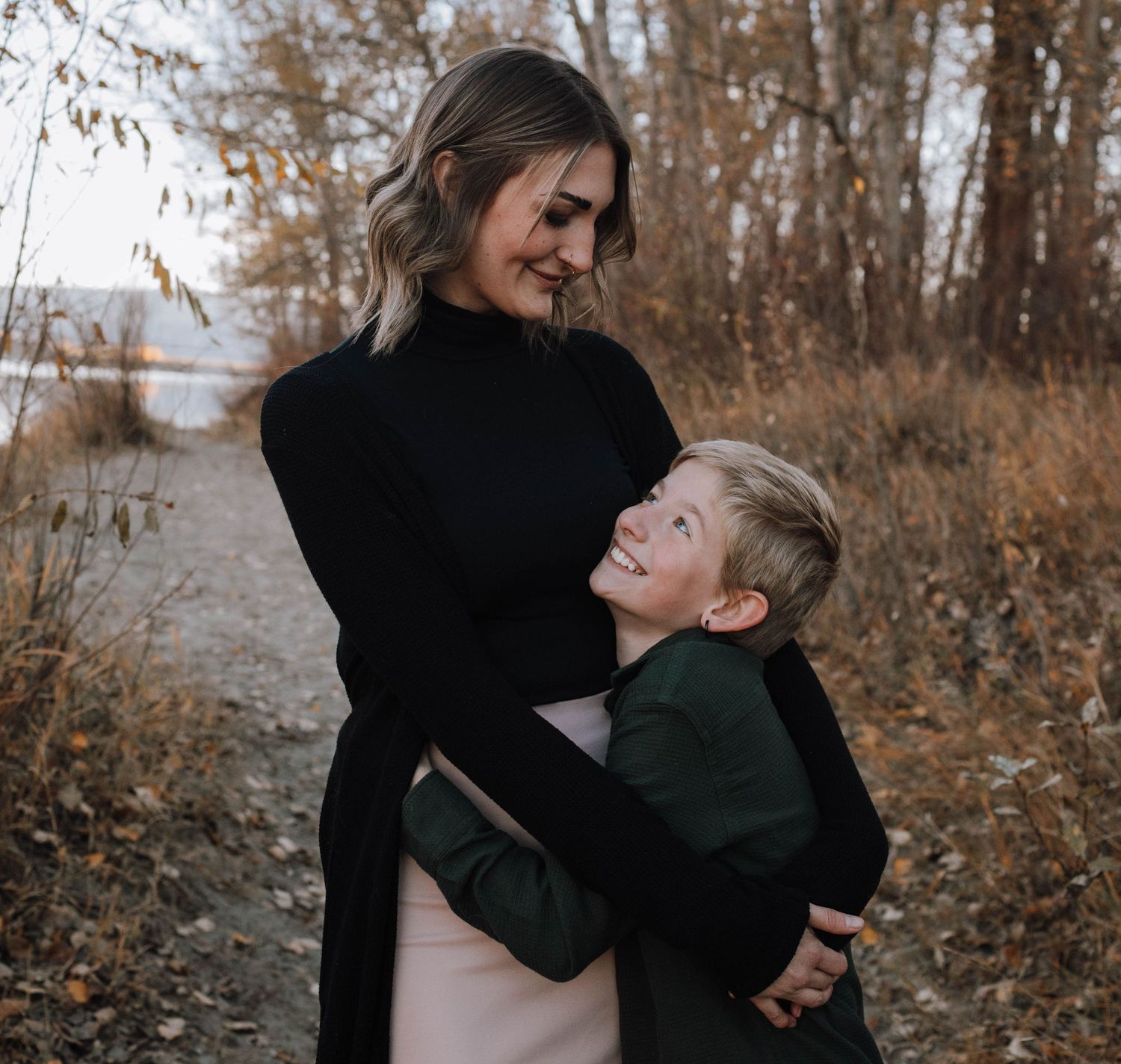 An intimate family moment captured on a fall nature path.