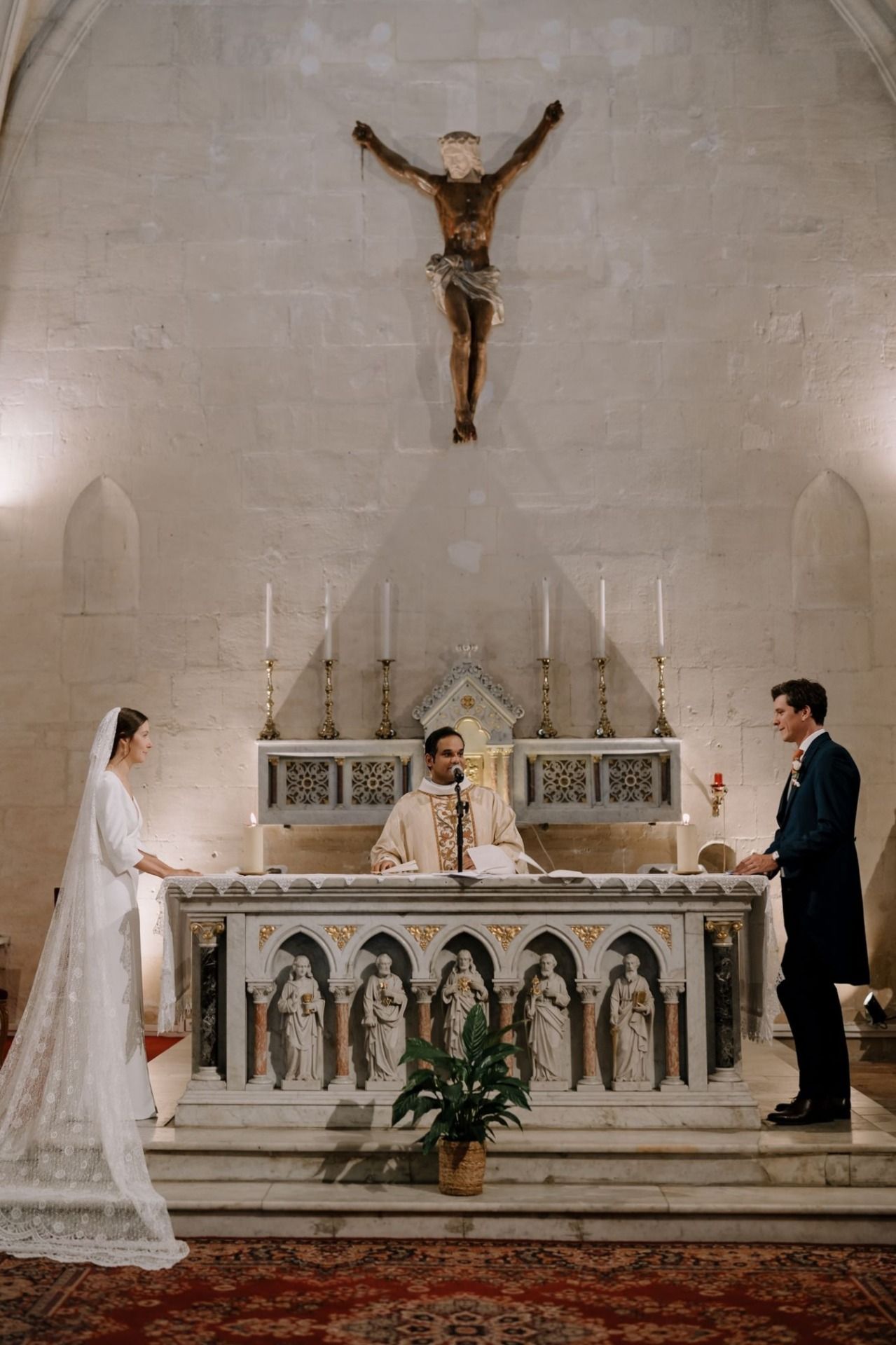 Wedding ceremony sequence in a traditional church with ornate altar and religious decorations.