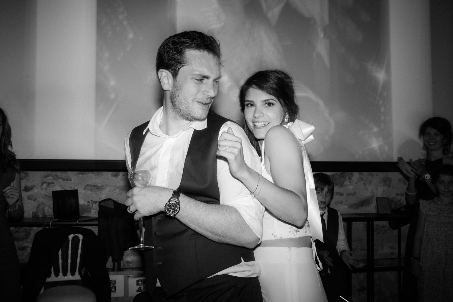 Couple sharing an intimate dance moment in dramatic black and white photography.