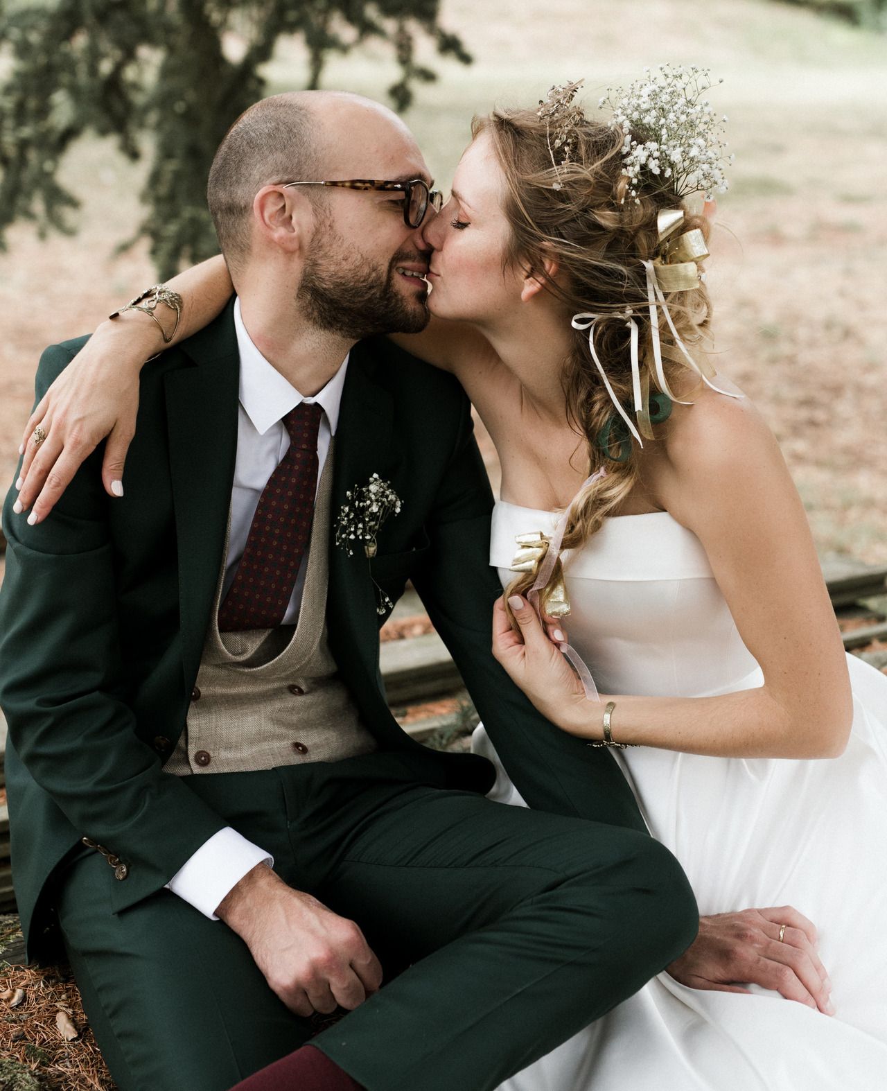 Romantic wedding photo series showing intimate moments between newlyweds on a bench.