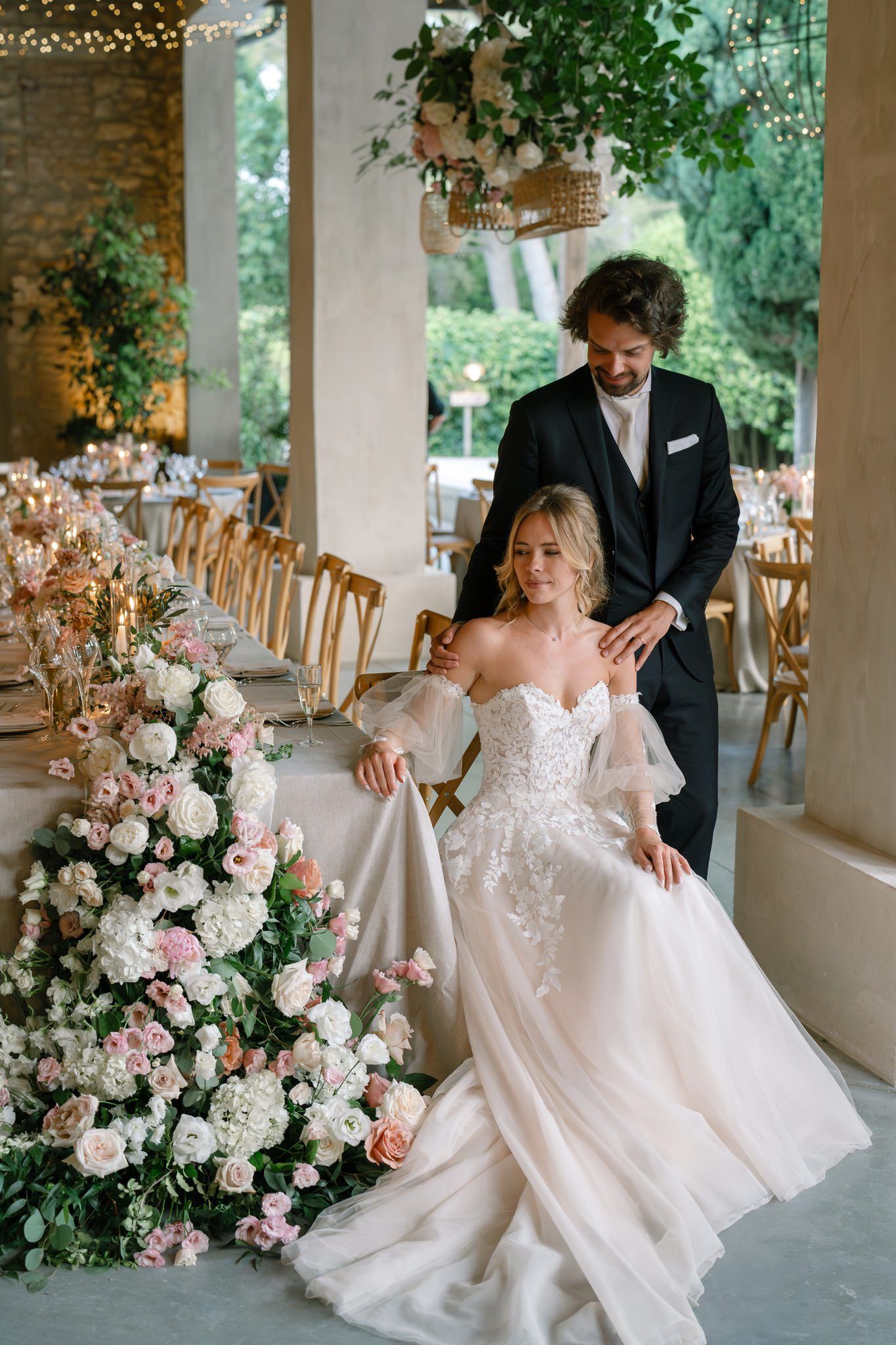Wedding venue decorated with lush floral arrangements and elegant table settings.