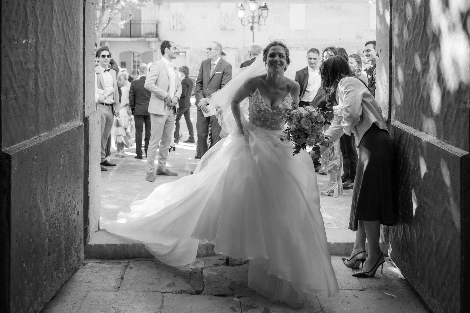 A wedding celebration in a historic passageway with flowing dress movement.