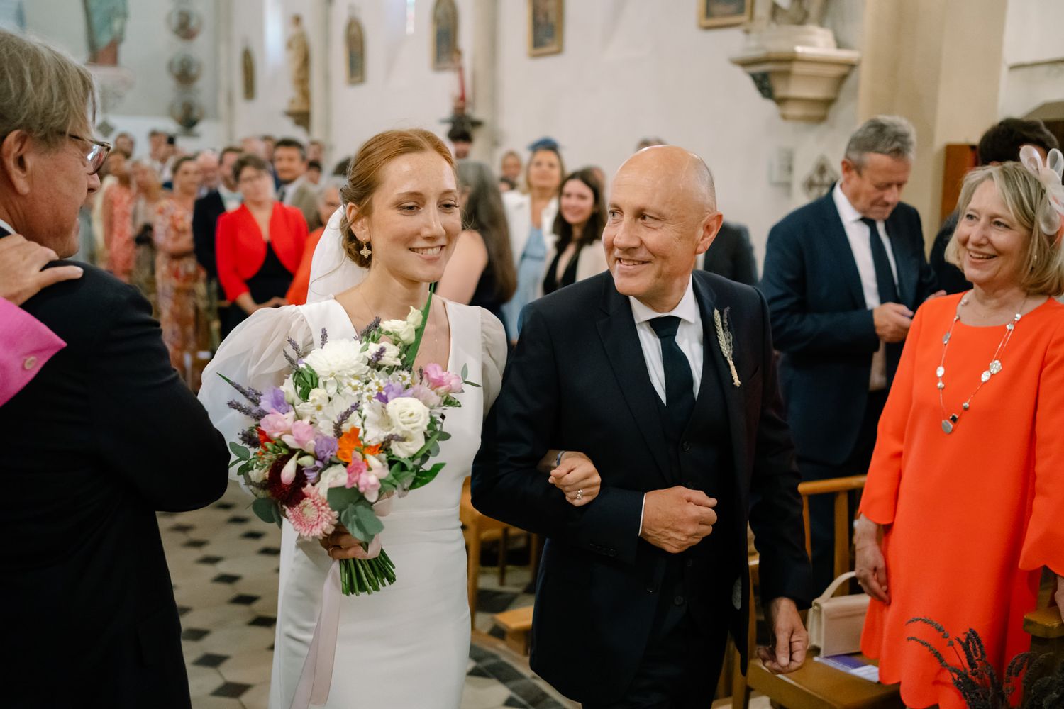 Guests celebrate during a joyous moment at an elegant church wedding ceremony.