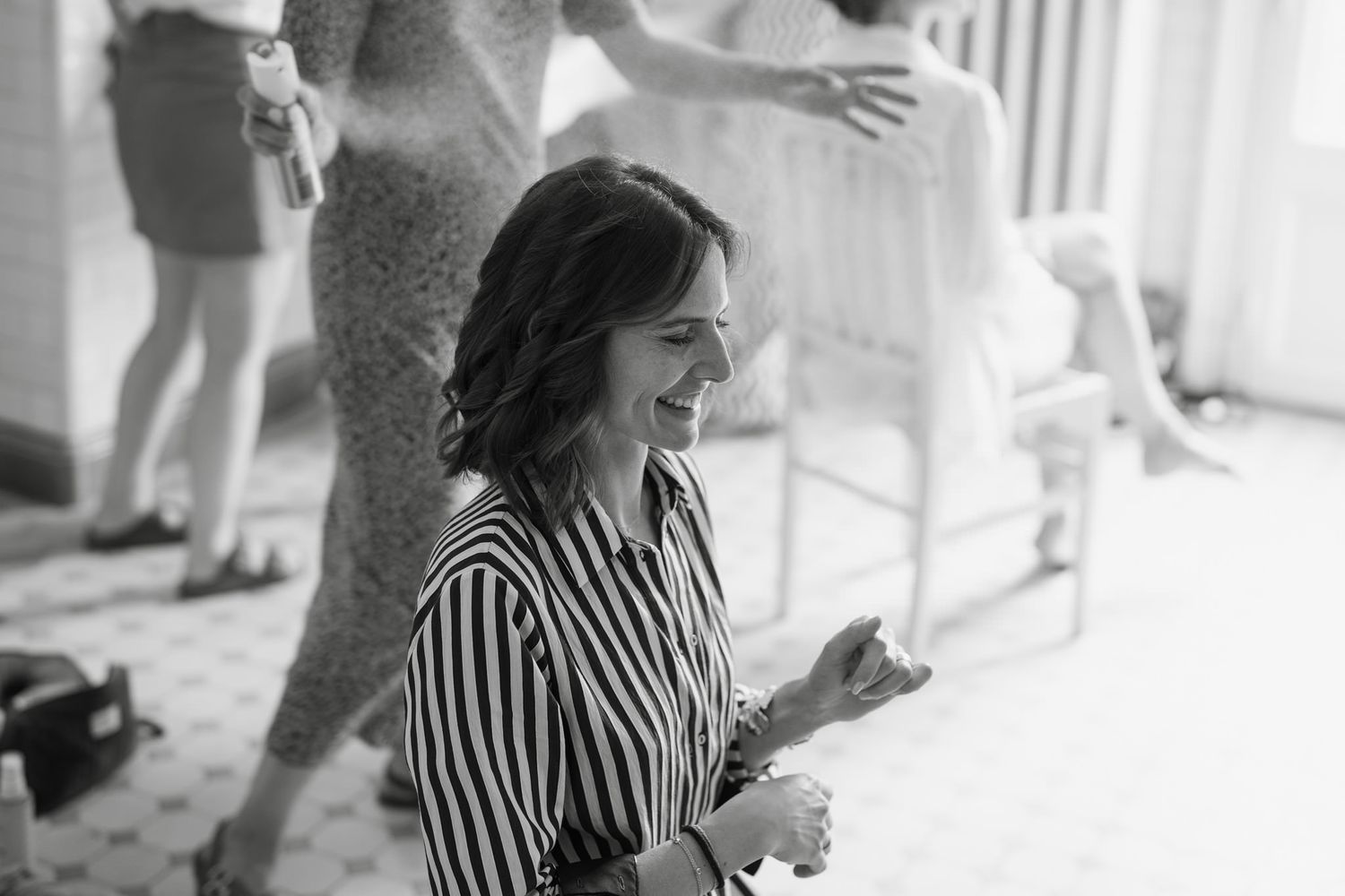 Black and white photo of guests enjoying a celebration on a porch.