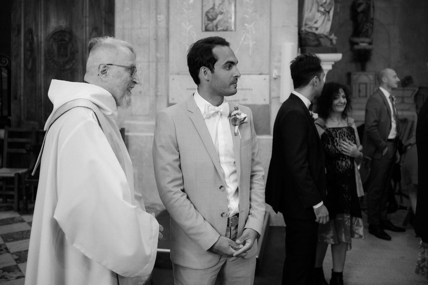 Documentary style black and white photos capturing candid moments during a church wedding ceremony.