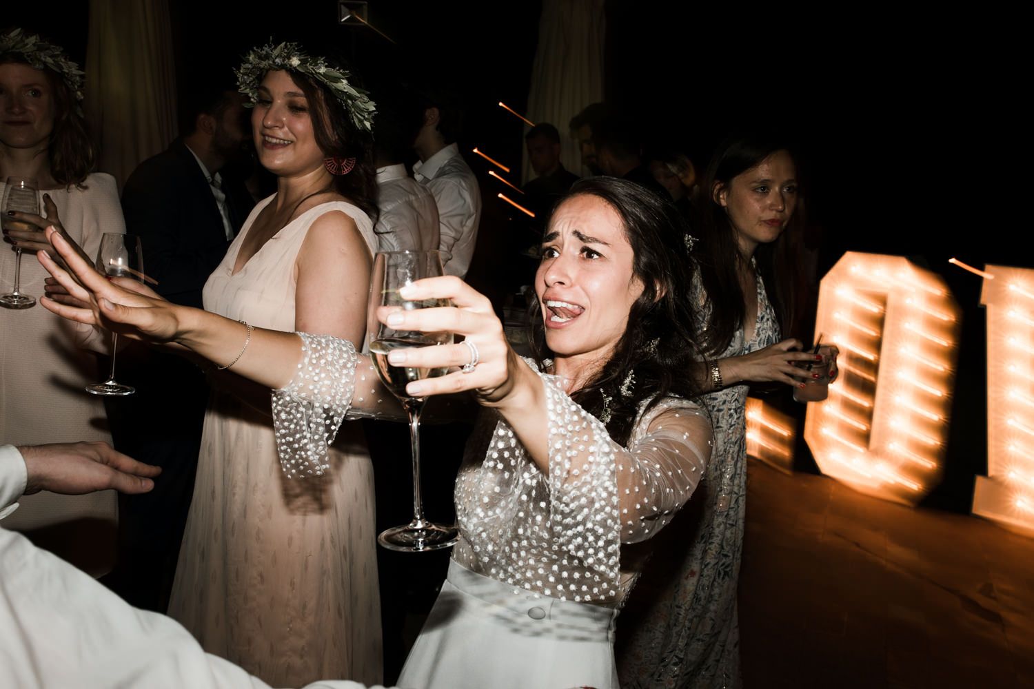 Party guests enjoying themselves on a dimly lit dance floor at an evening celebration.