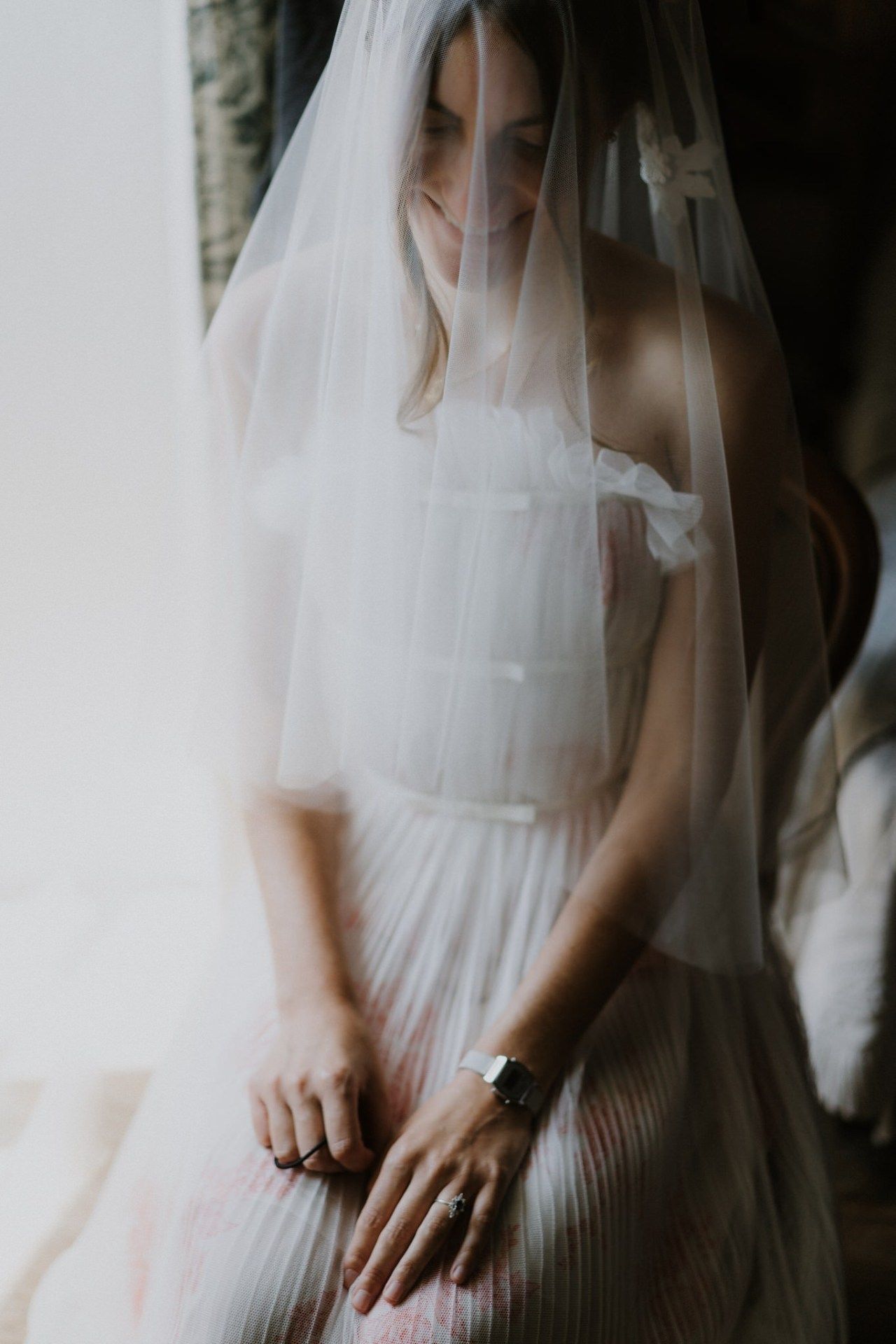 Detail shots of bride's dress and veil in soft, ethereal lighting.