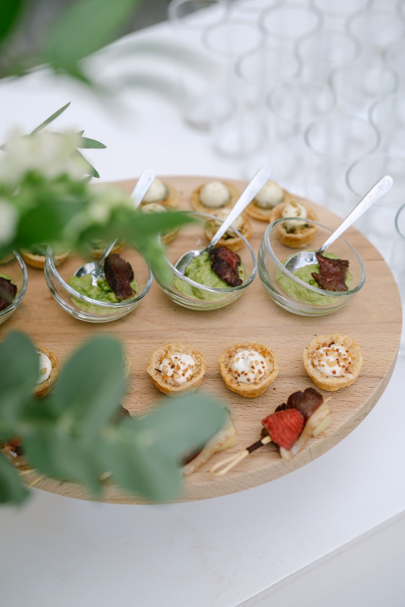 Elegant appetizers and hors d'oeuvres arranged on wooden serving boards.